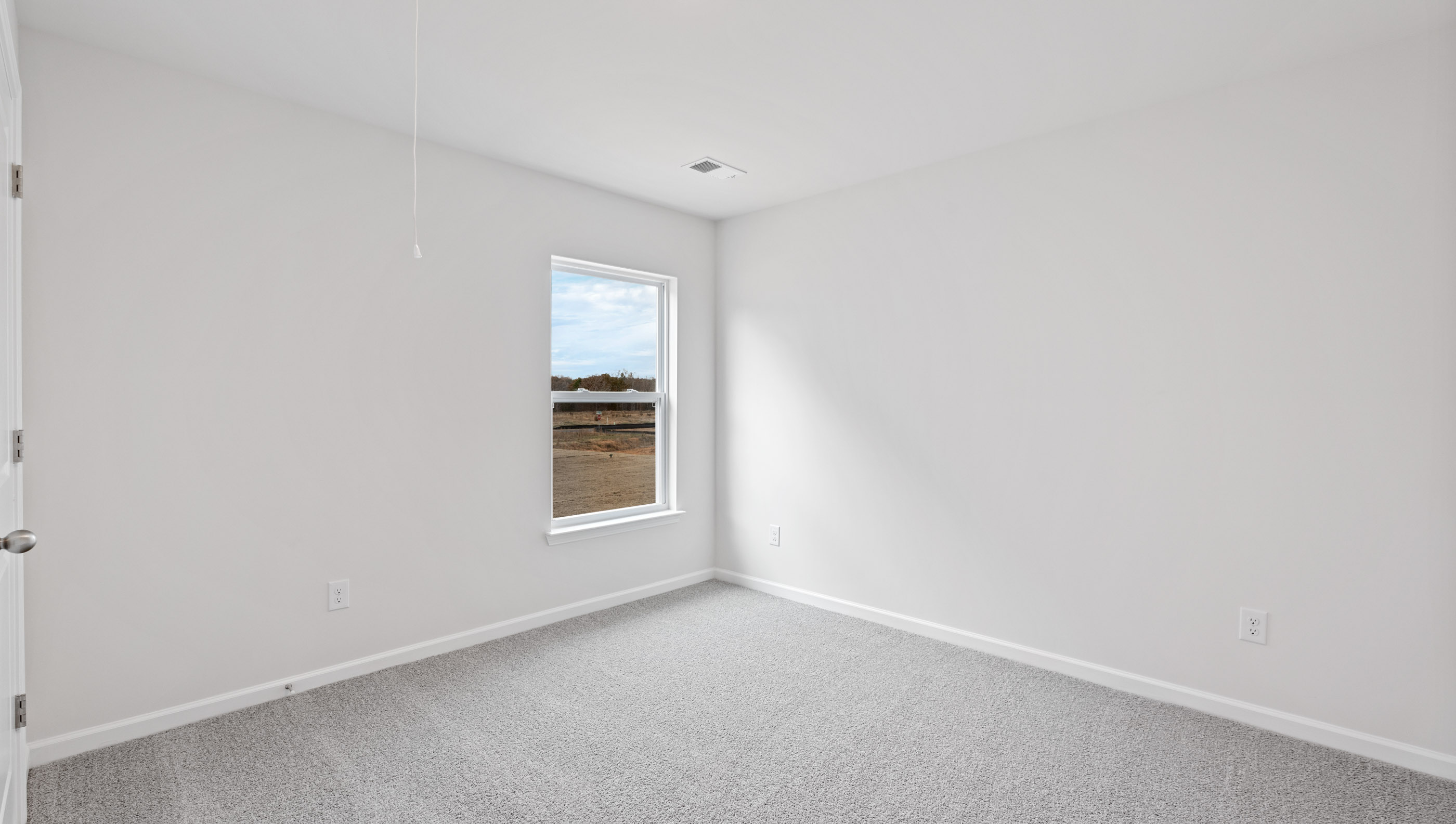 Bedroom with carpet and windows.