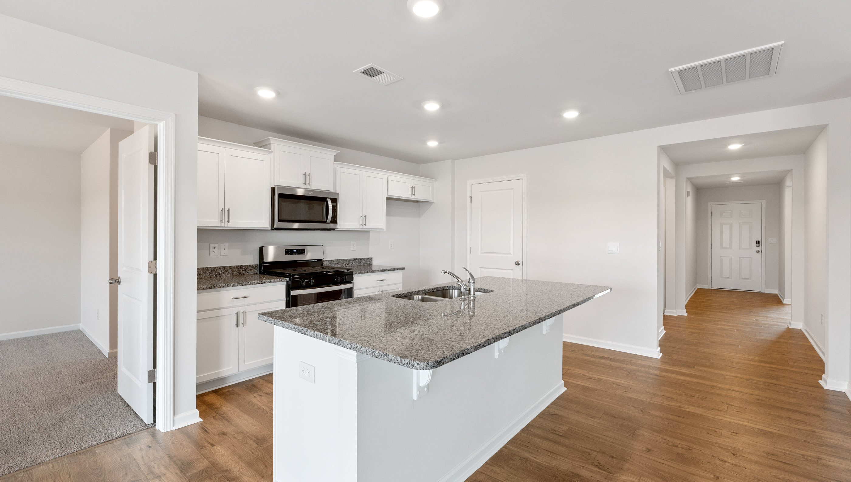 Kitchen and island with granite countertops.
