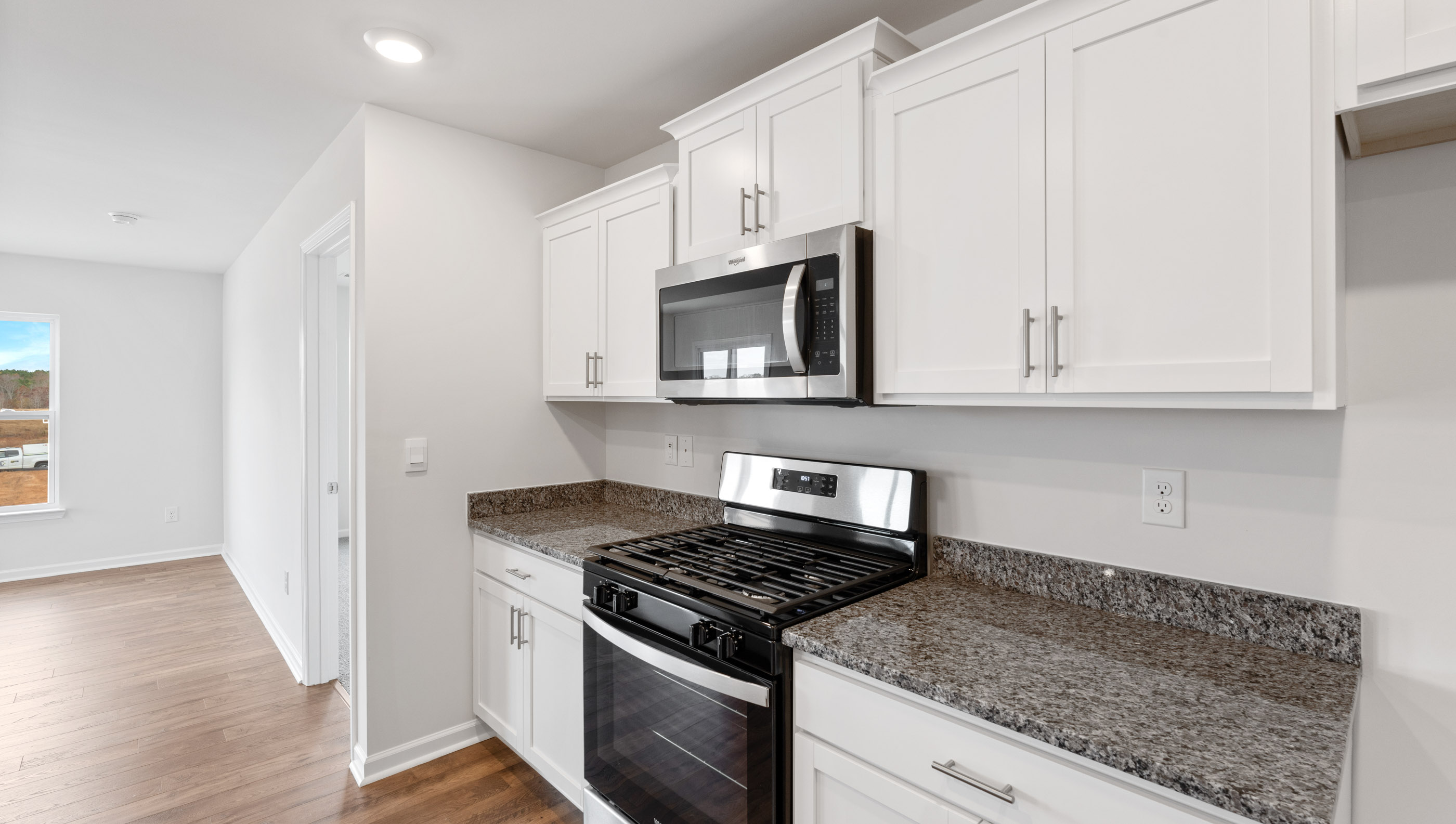 Kitchen with granite countertops and stainless steel appliances.