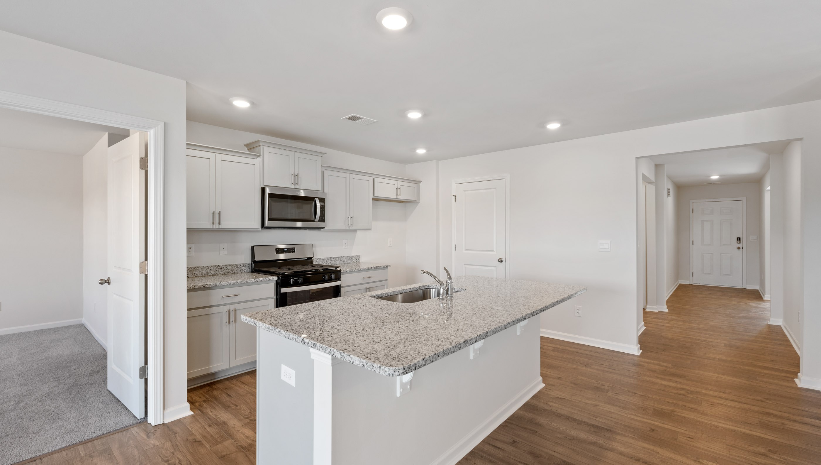 Kitchen with island and granite countertops.