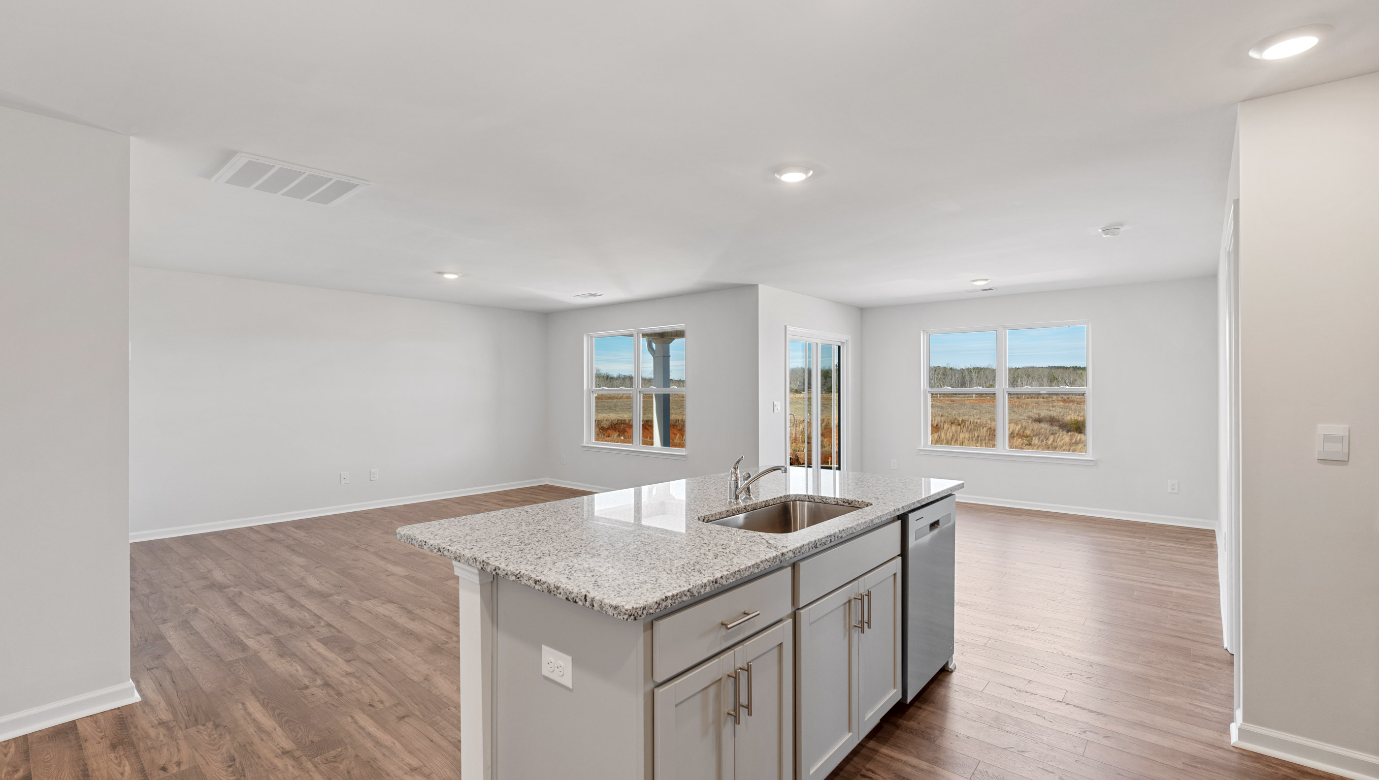 Kitchen with island and granite countertops.