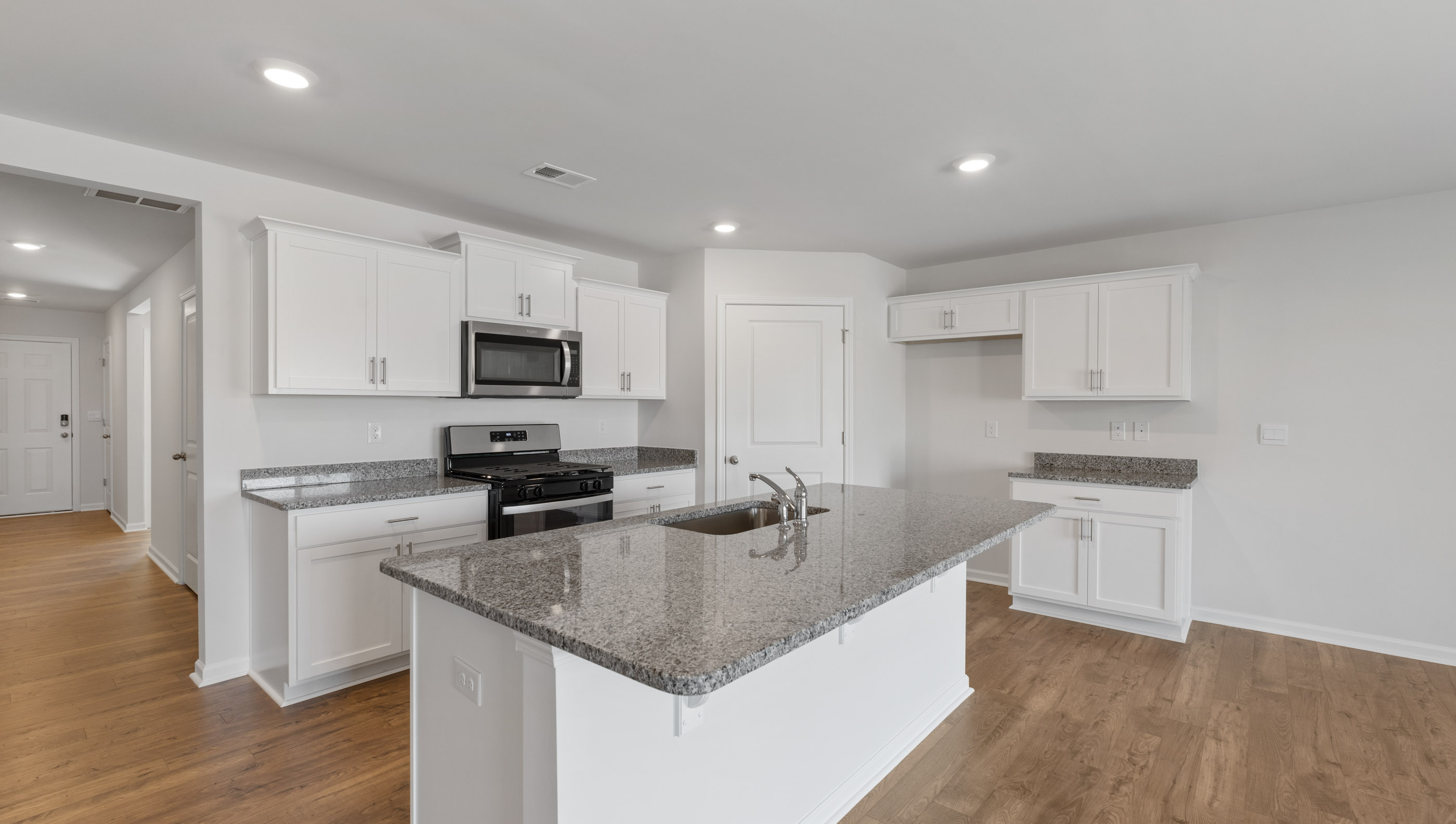 Kitchen and island with granite countertops.