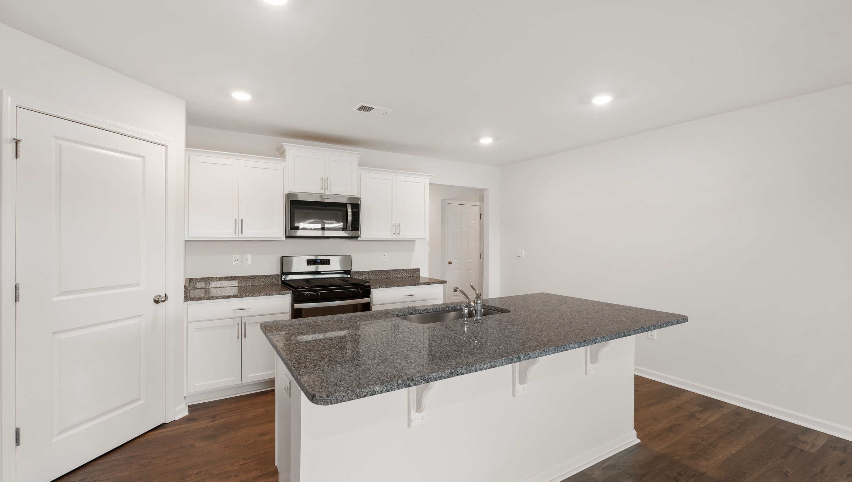 Kitchen and island with granite countertops.