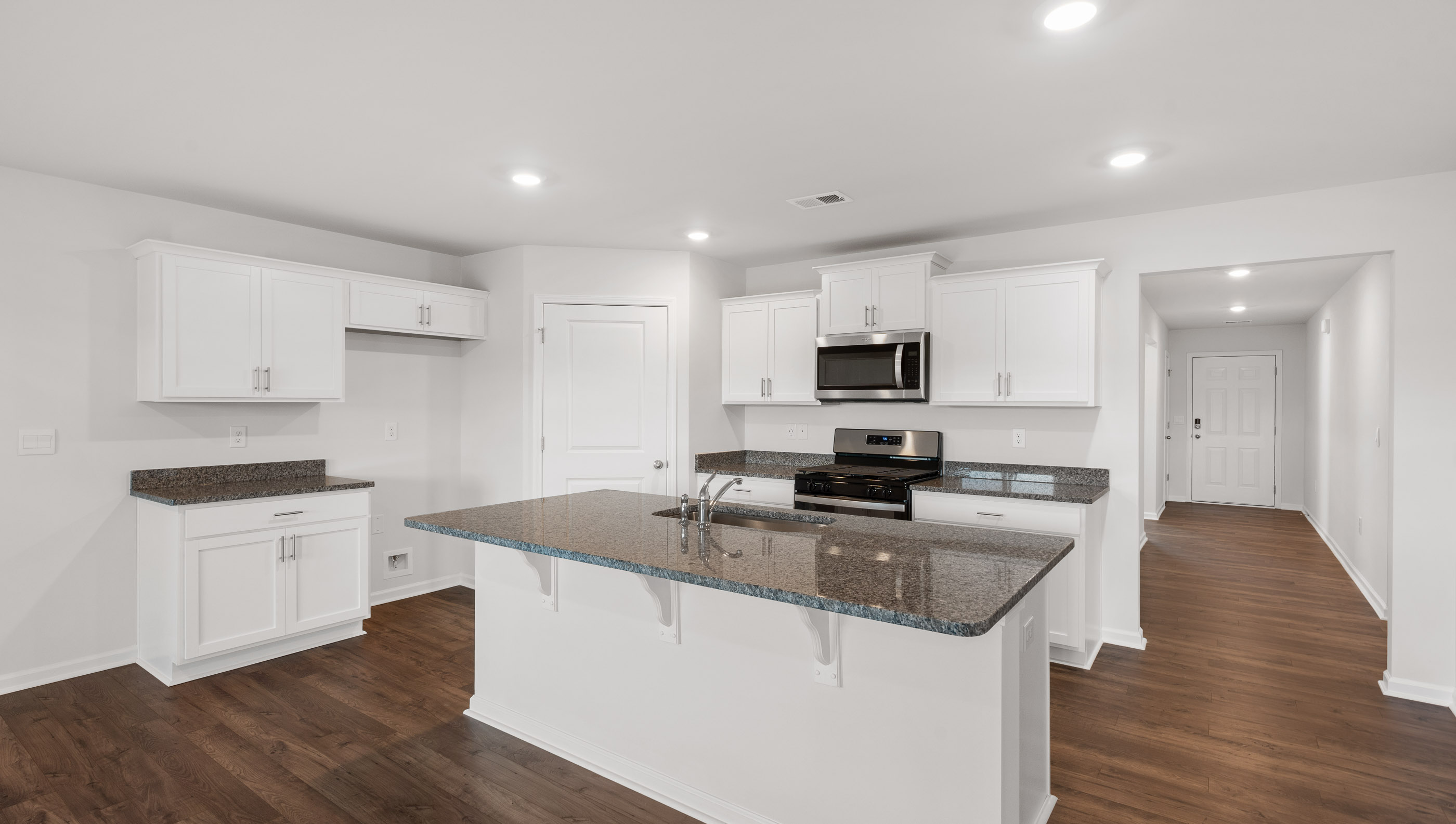 Kitchen and island with granite countertops.