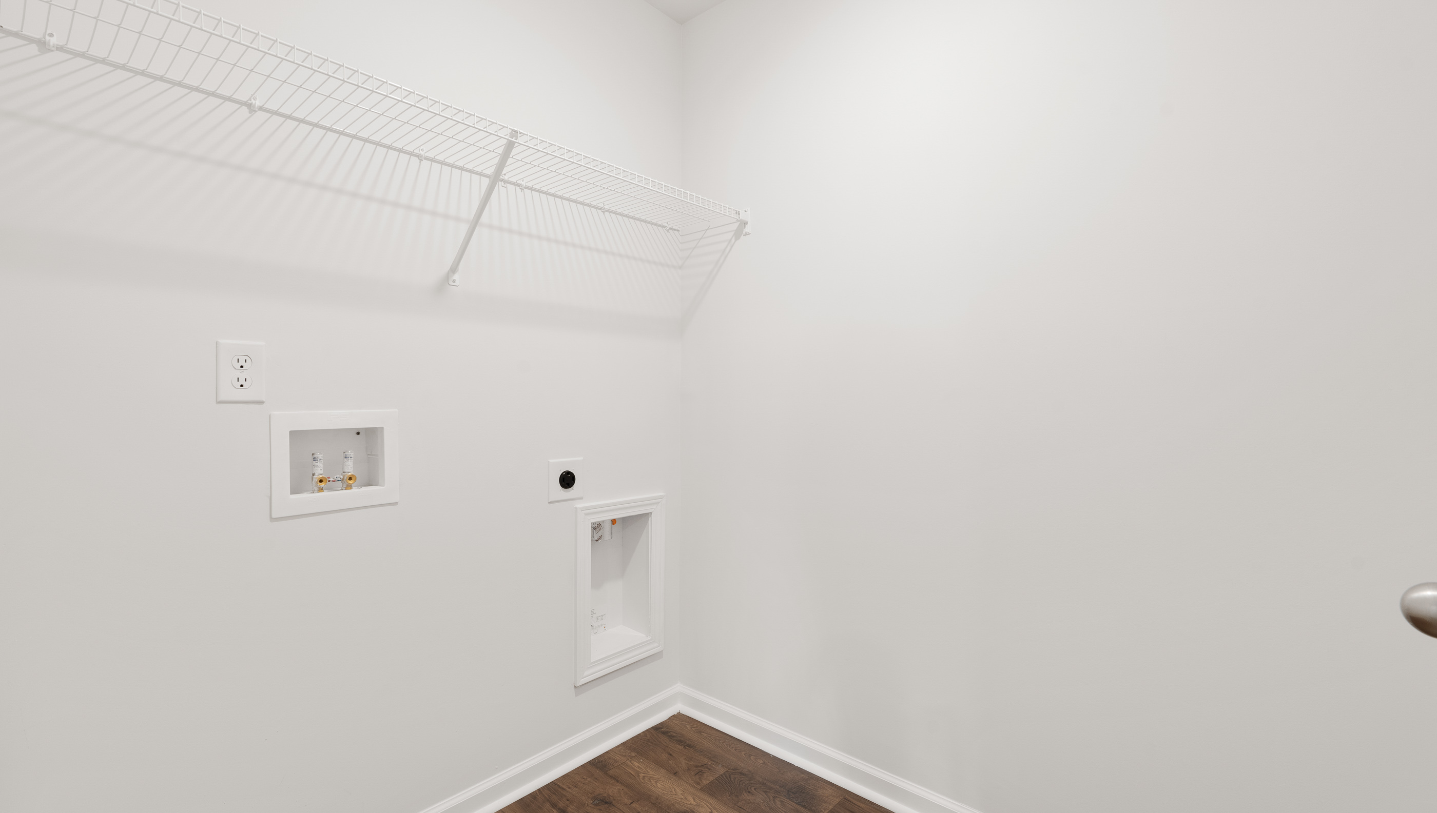 Walk in laundry with shelves.