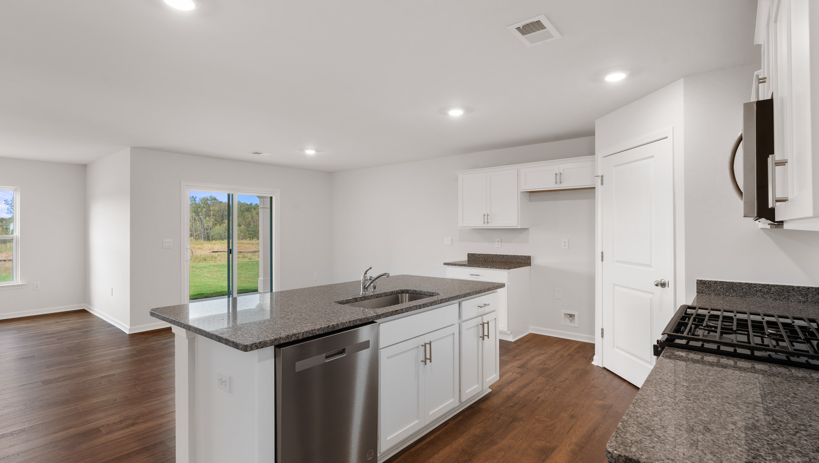 Kitchen and island with granite countertops.