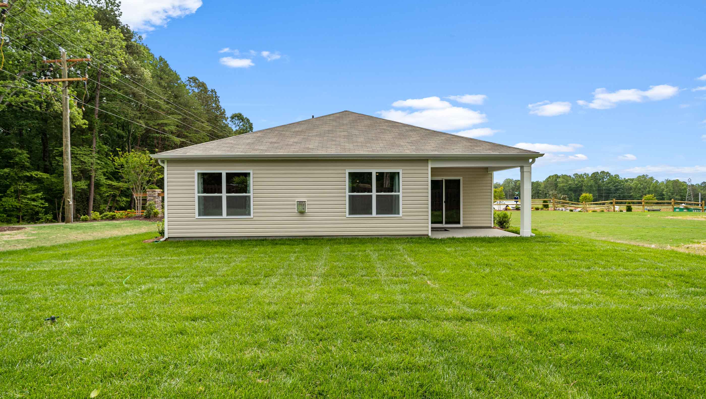 Exterior of home with large backyard.
