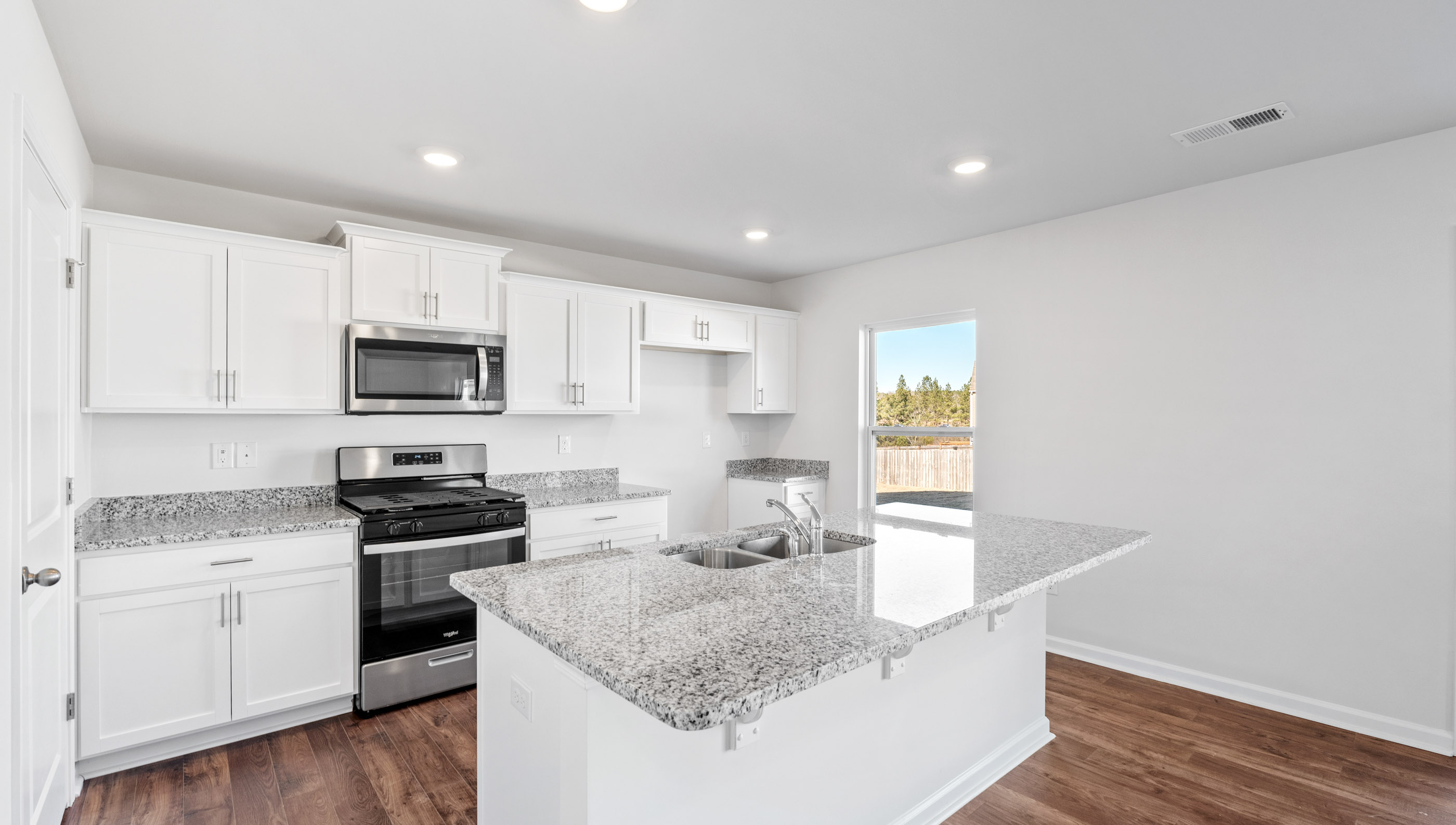 Kitchen and island with granite countertops.