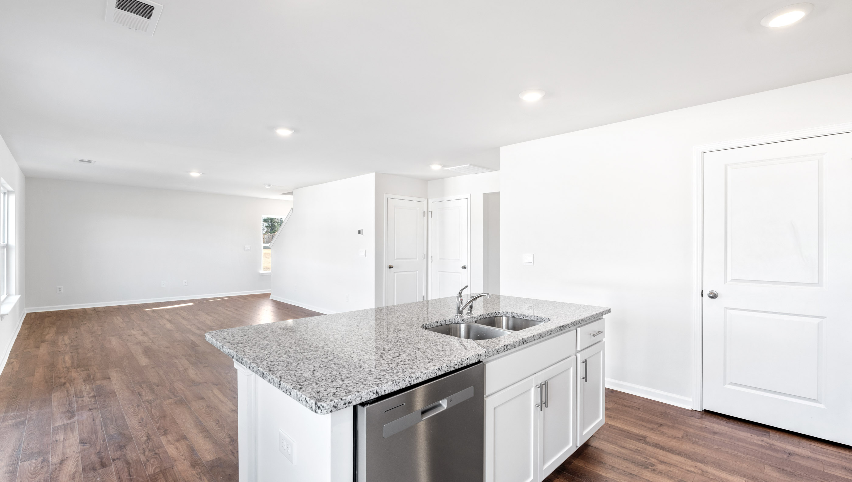 Kitchen and island with granite countertops.