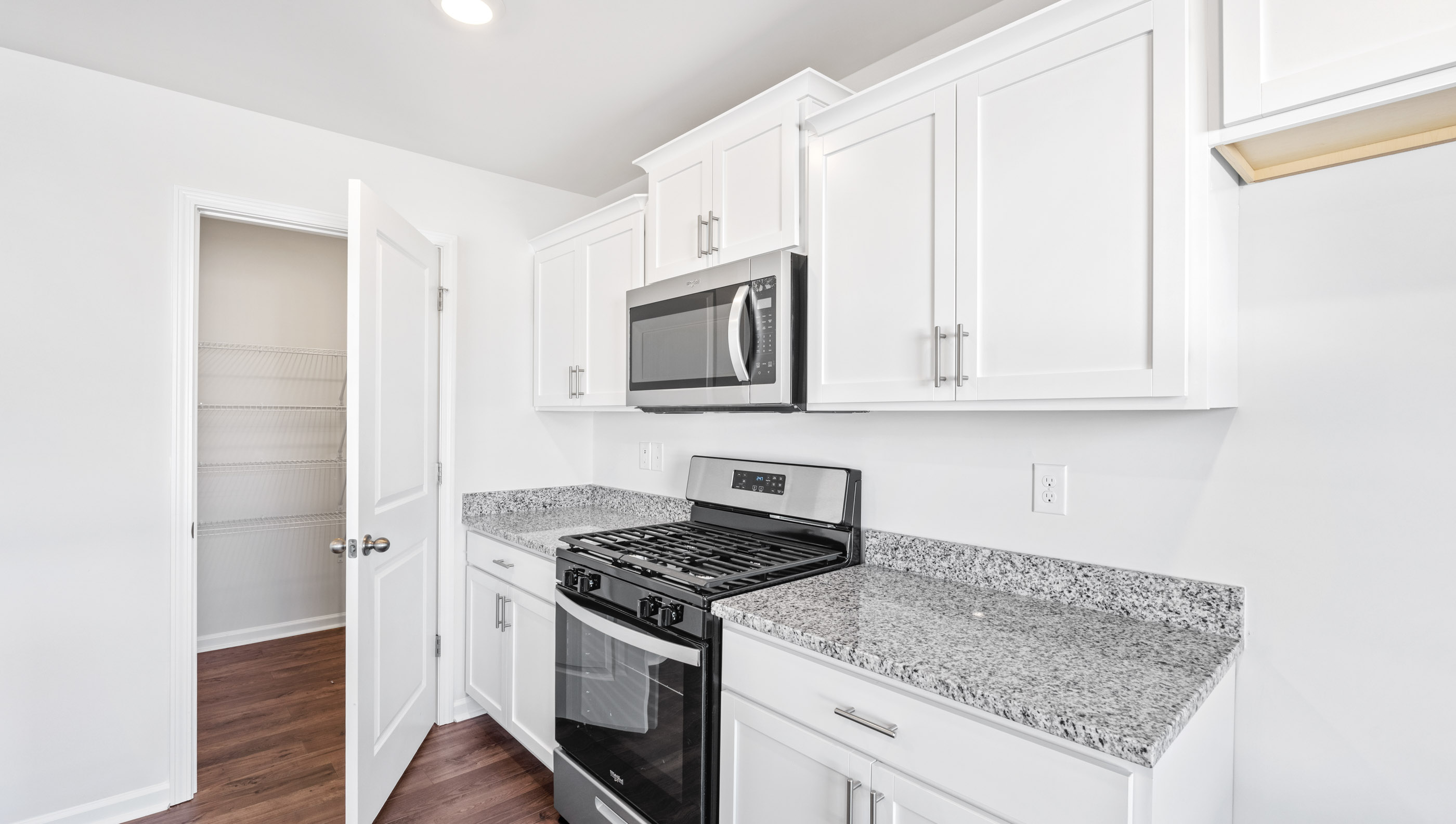 Kitchen with granite countertops and stainless steel appliances.