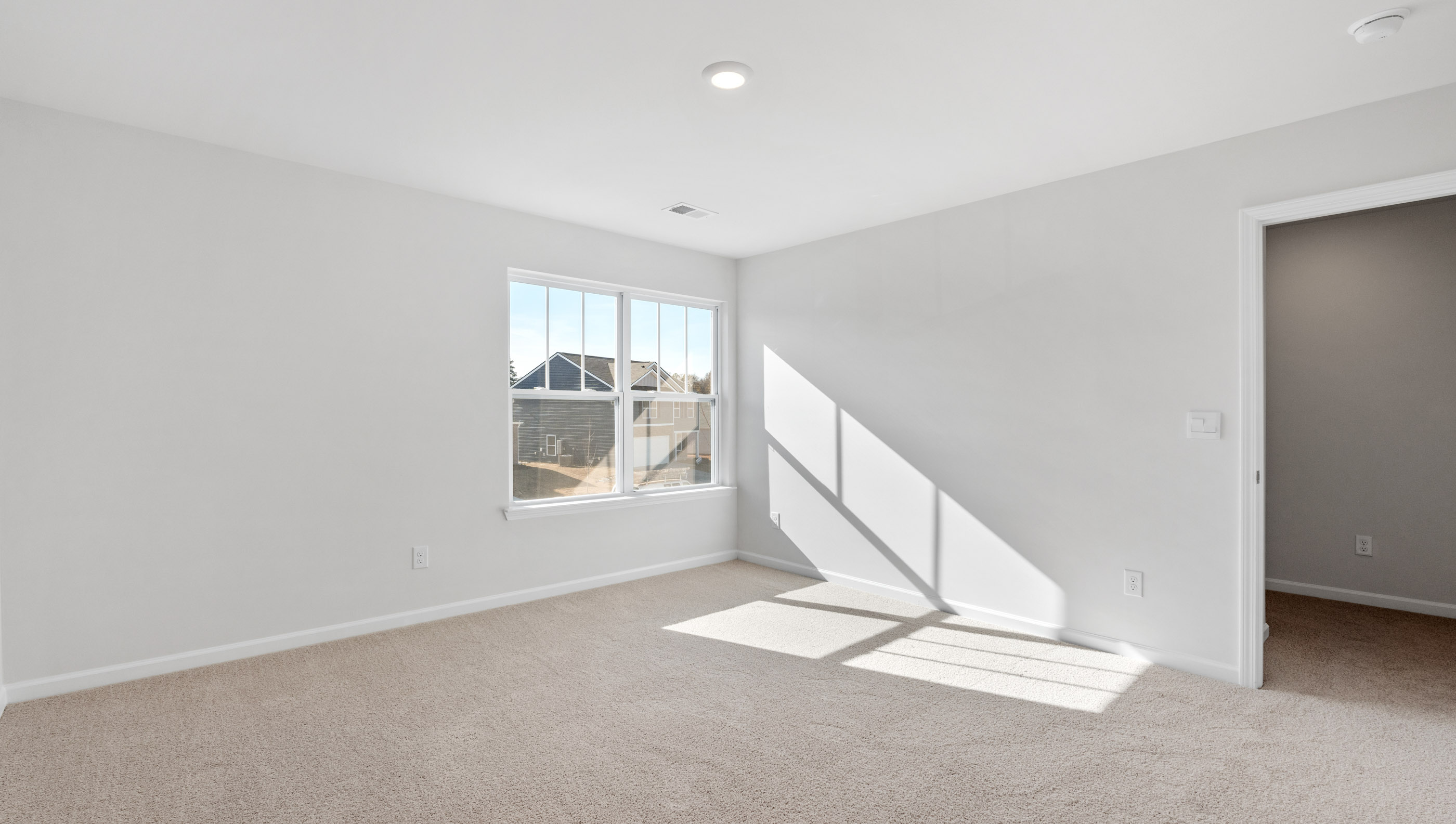 Bedroom with carpet and windows.