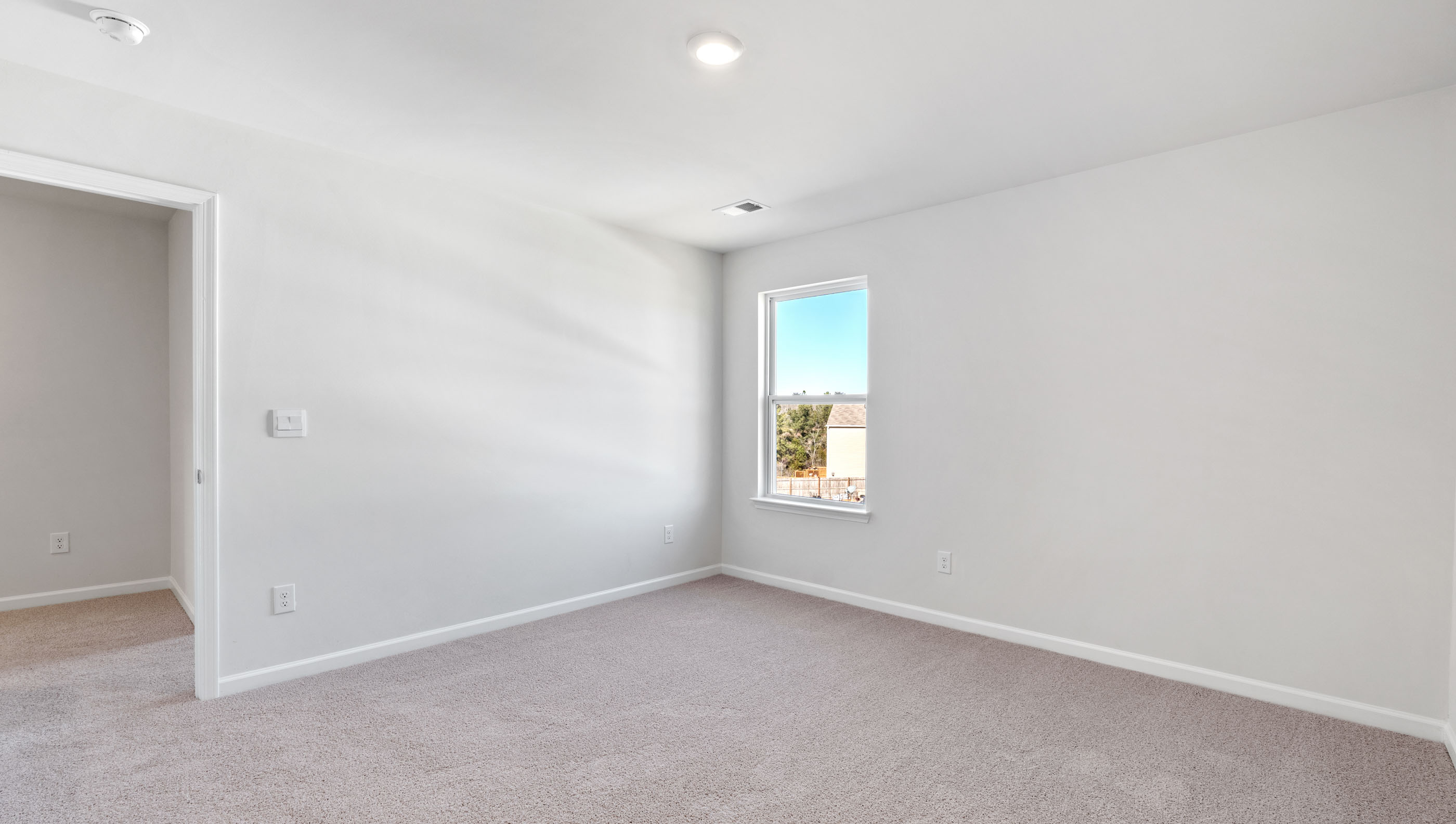 Bedroom with carpet and windows.