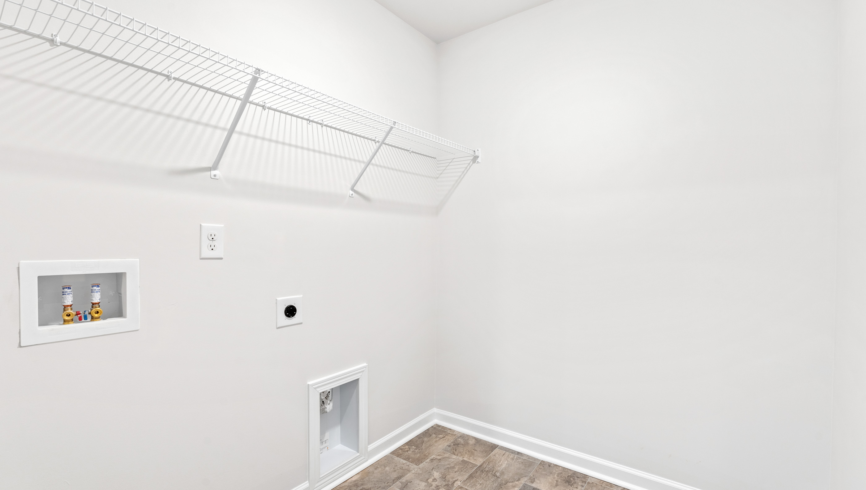 Walk in laundry with shelves.