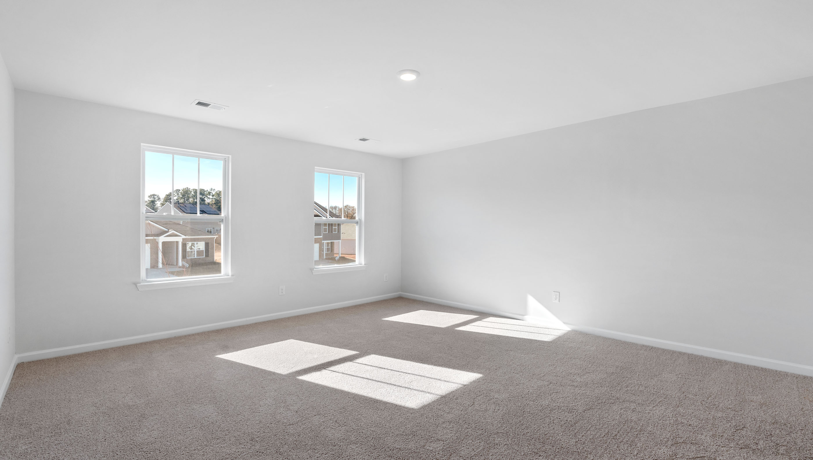 Bedroom with carpet and vanity.
