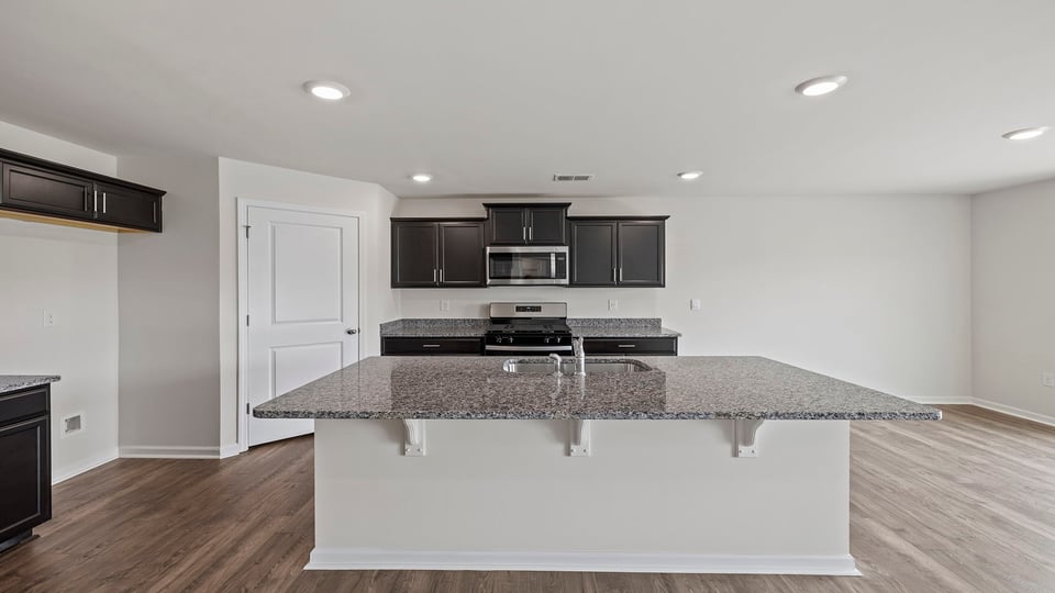 Kitchen and island with granite countertops.
