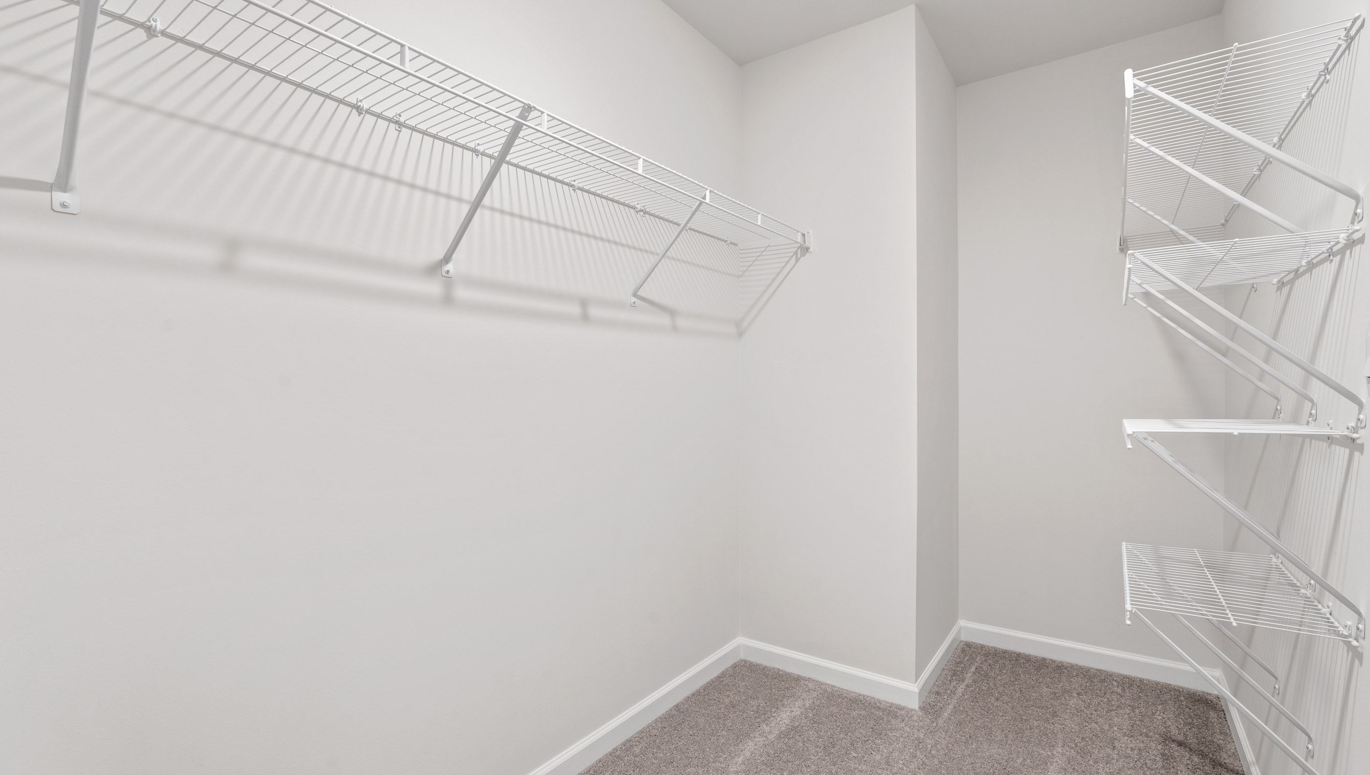 Walk in closet with shelves.