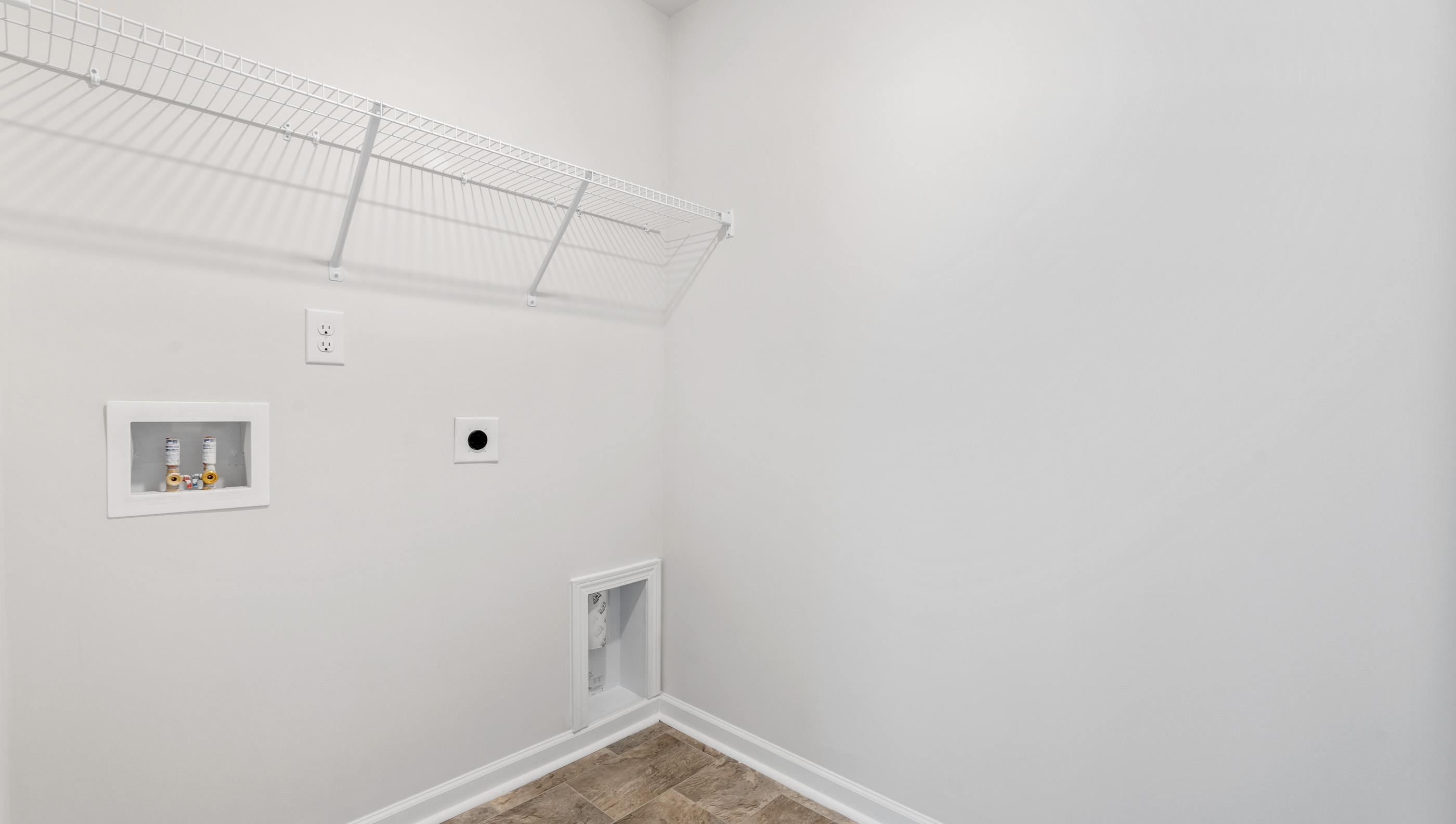 Walk in laundry with shelves.