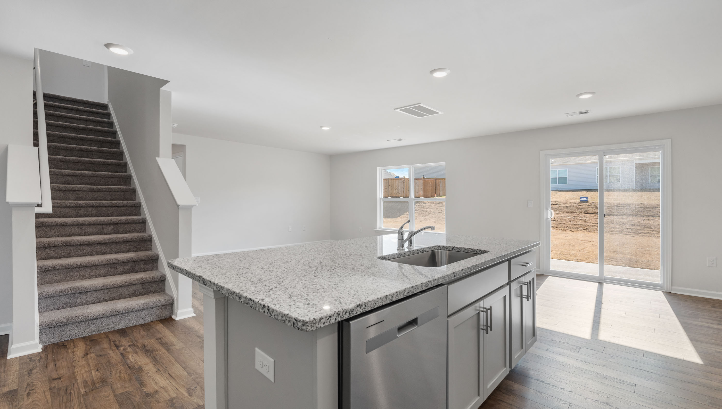 Kitchen with island and granite countertops.