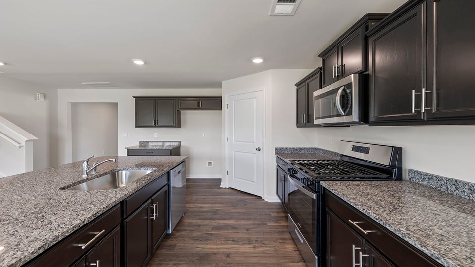 Kitchen and island with granite and countertops.