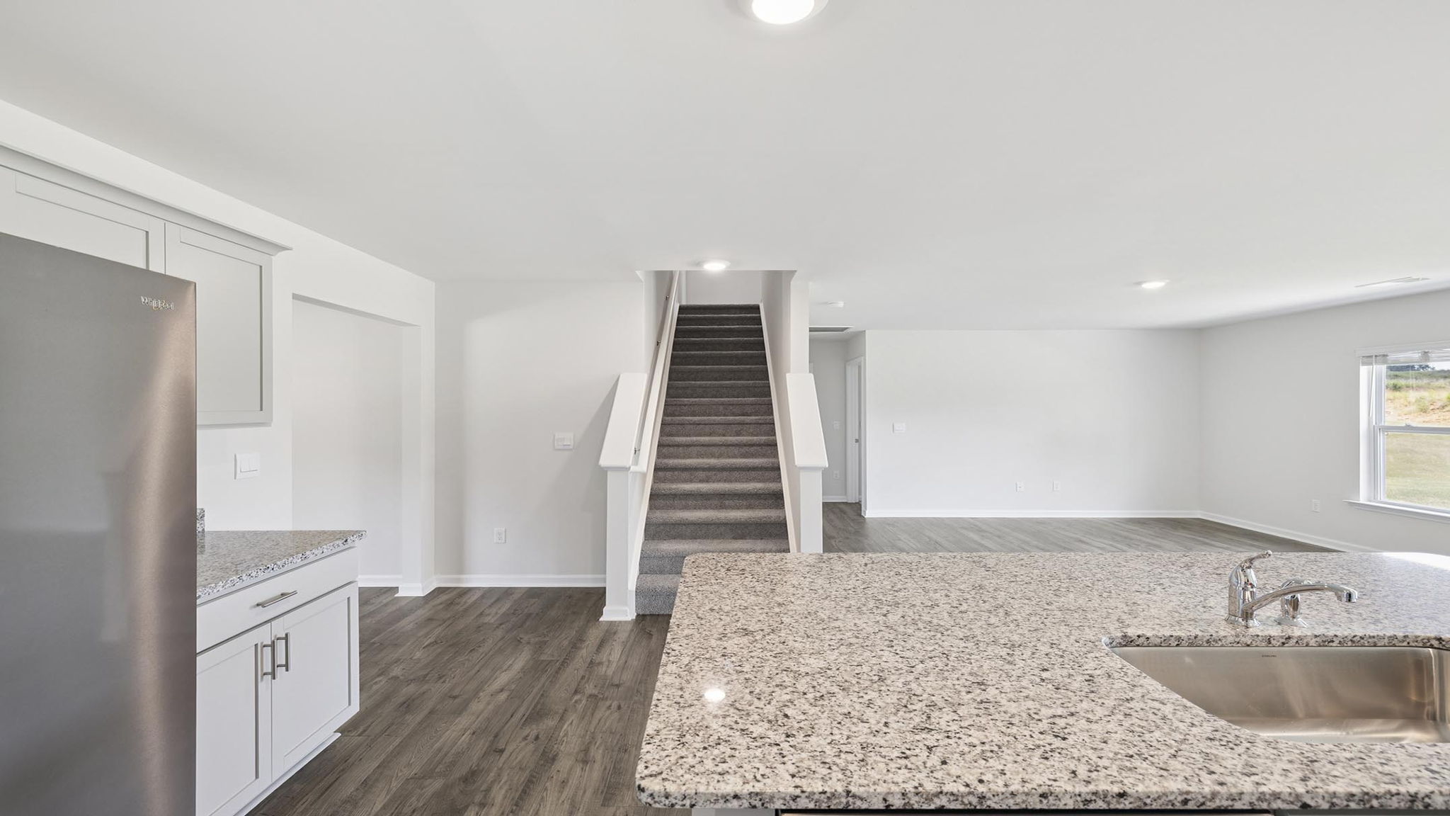 Kitchen with island and granite countertops.