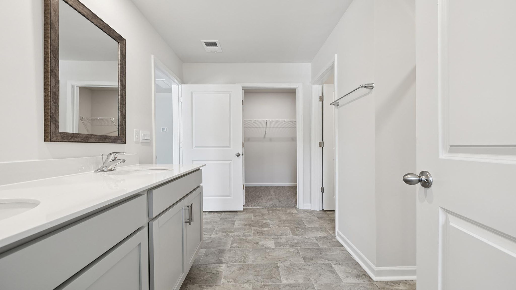 Bathroom with dual vanity and walk in shower.