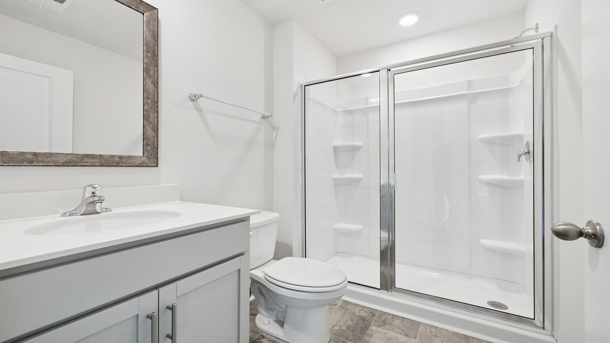 Bathroom with vanity and walk in shower.