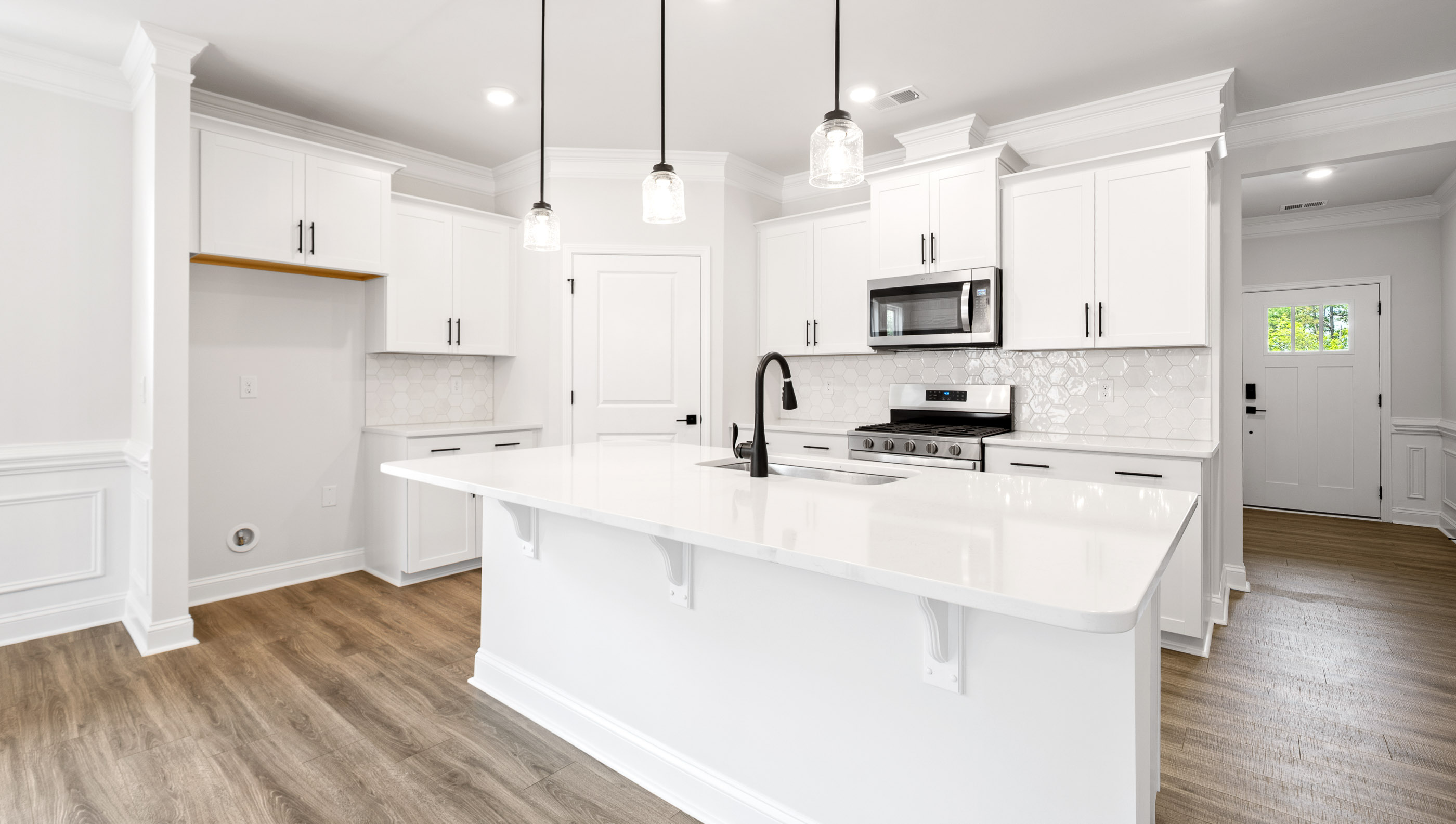 Kitchen and island with granite counter tops.