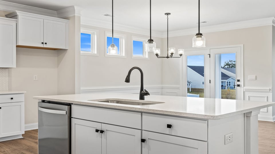 Kitchen and island with granite countertops.