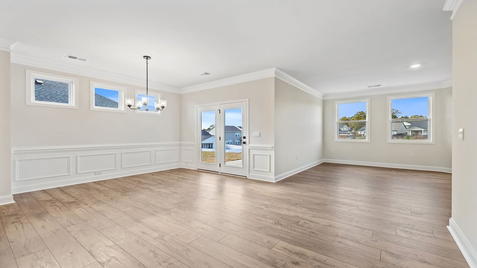Dining room and living room with windows.