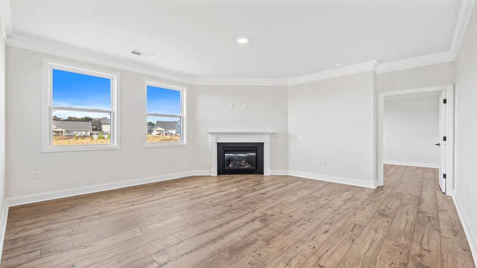 Living room with windows and fireplace.