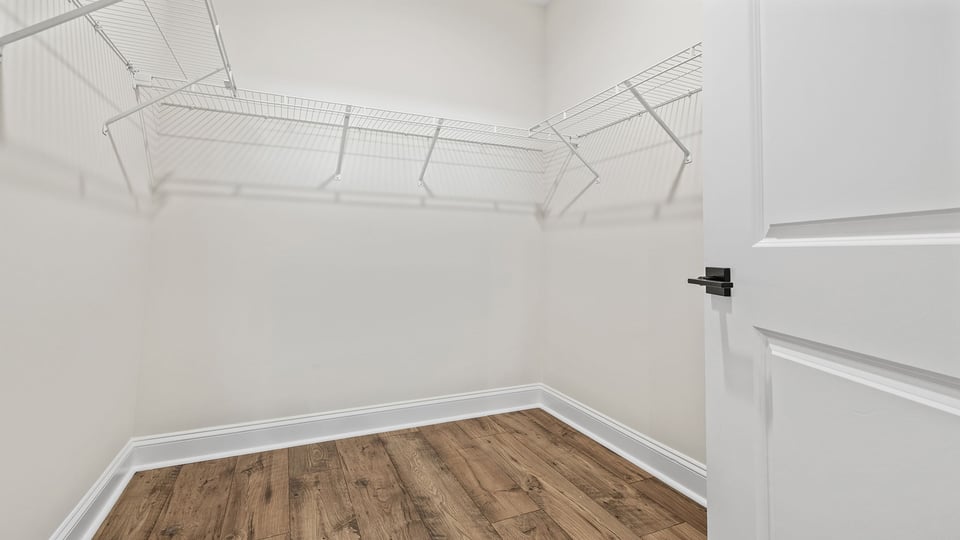 Walk in closet with shelves.