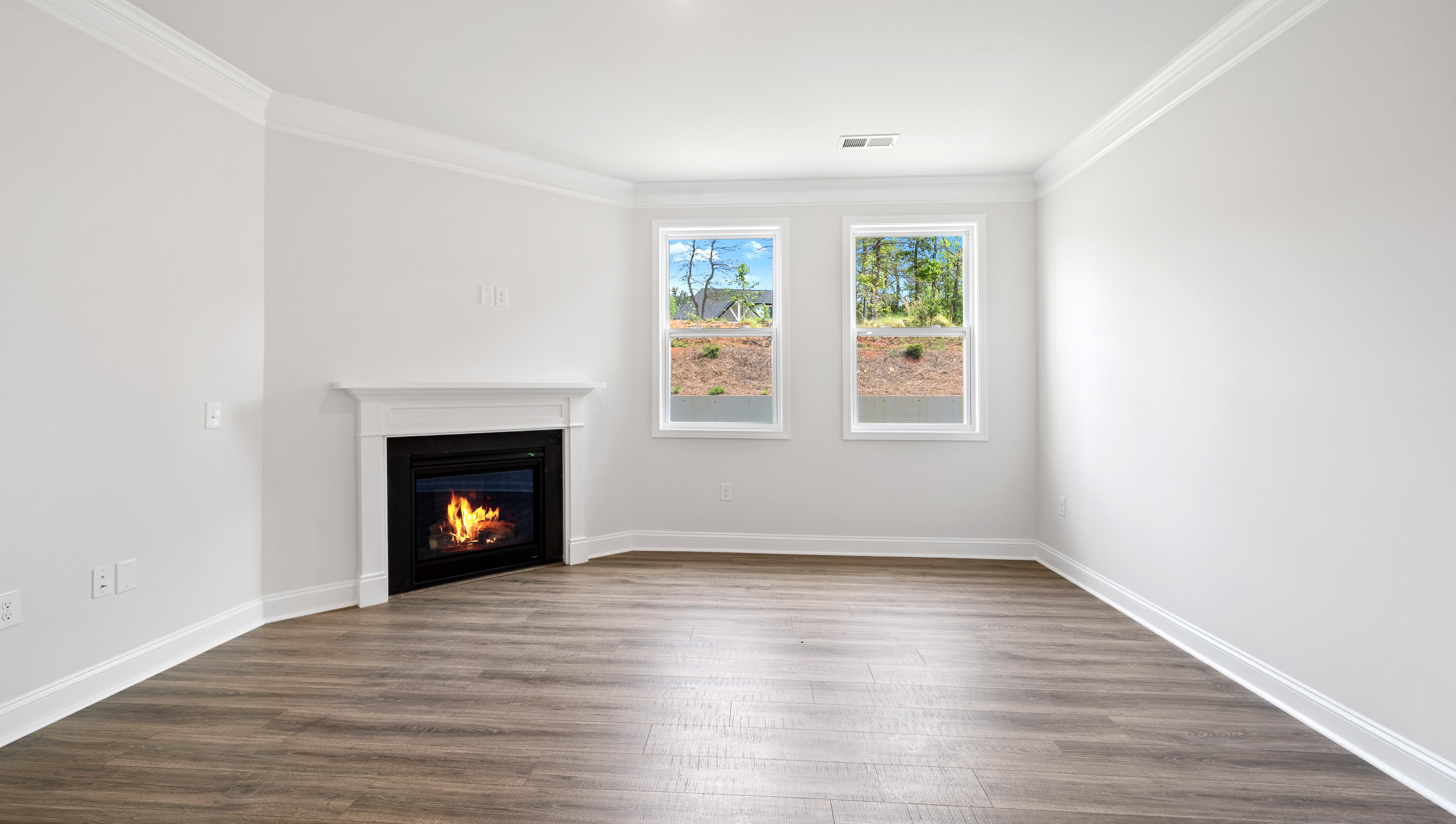 Family room with windows and fireplace.