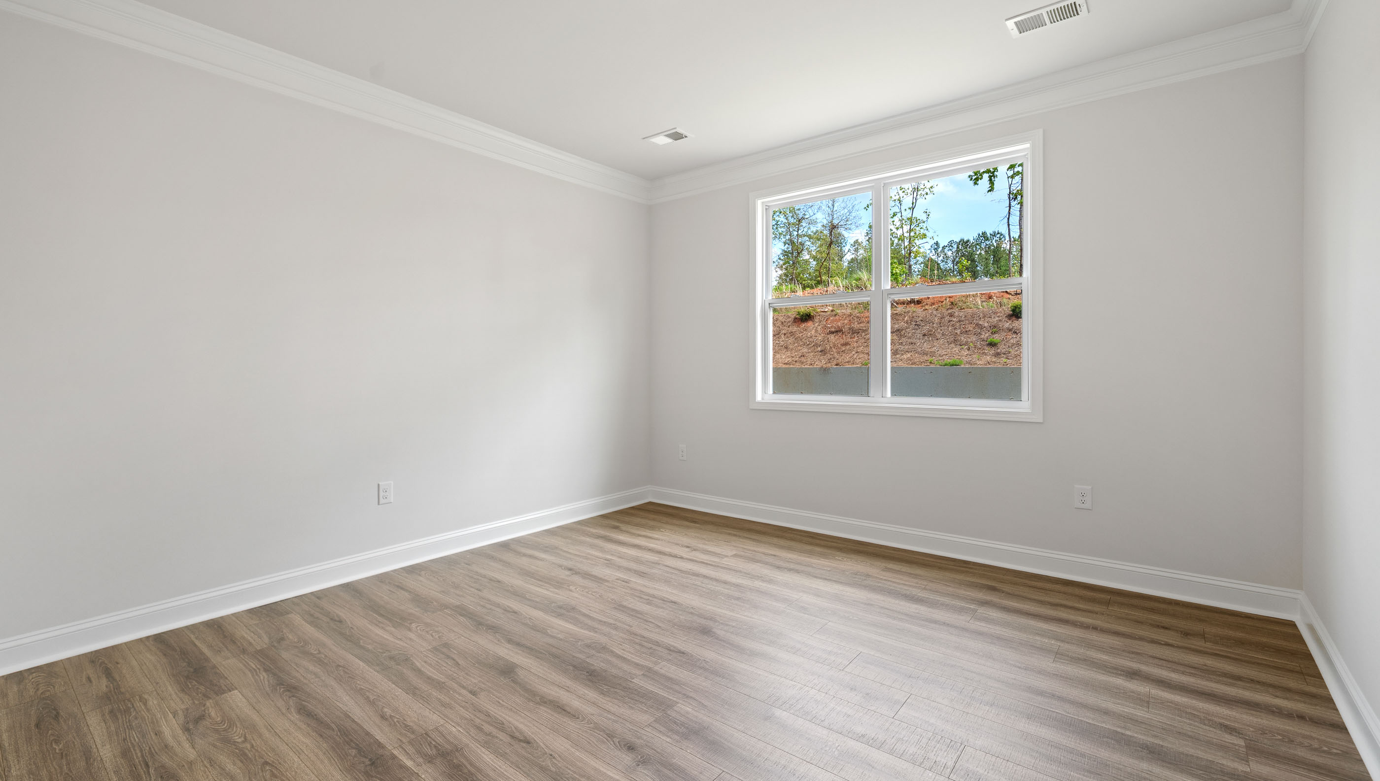 Bedroom with carpet and window.