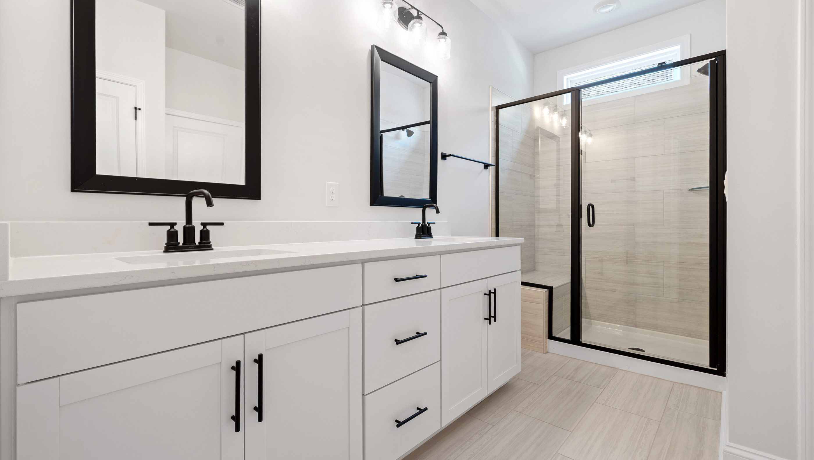 Bathroom with shower and sinks.
