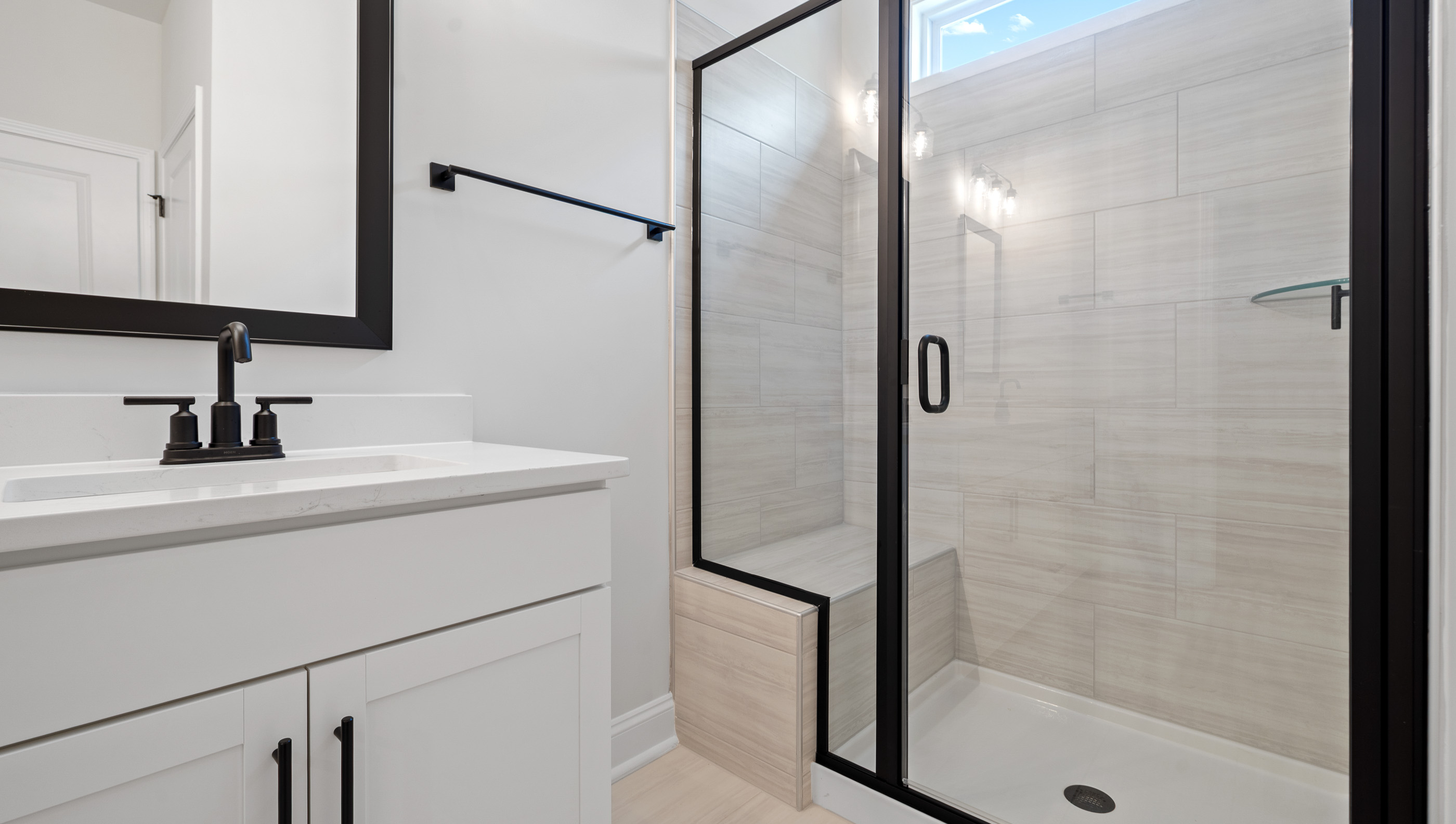 Bathroom with shower and sinks.