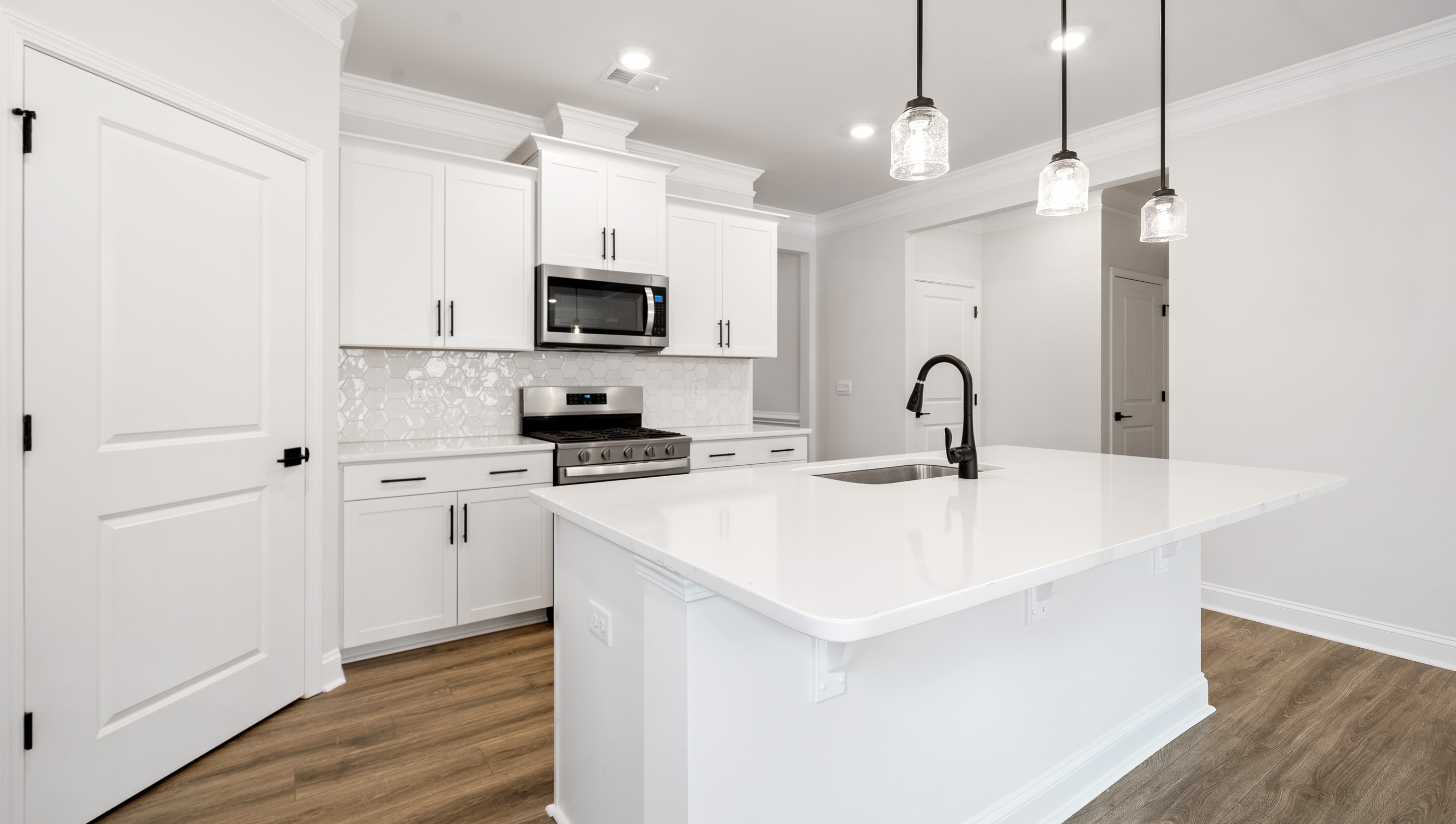Kitchen and island with granite counter tops.