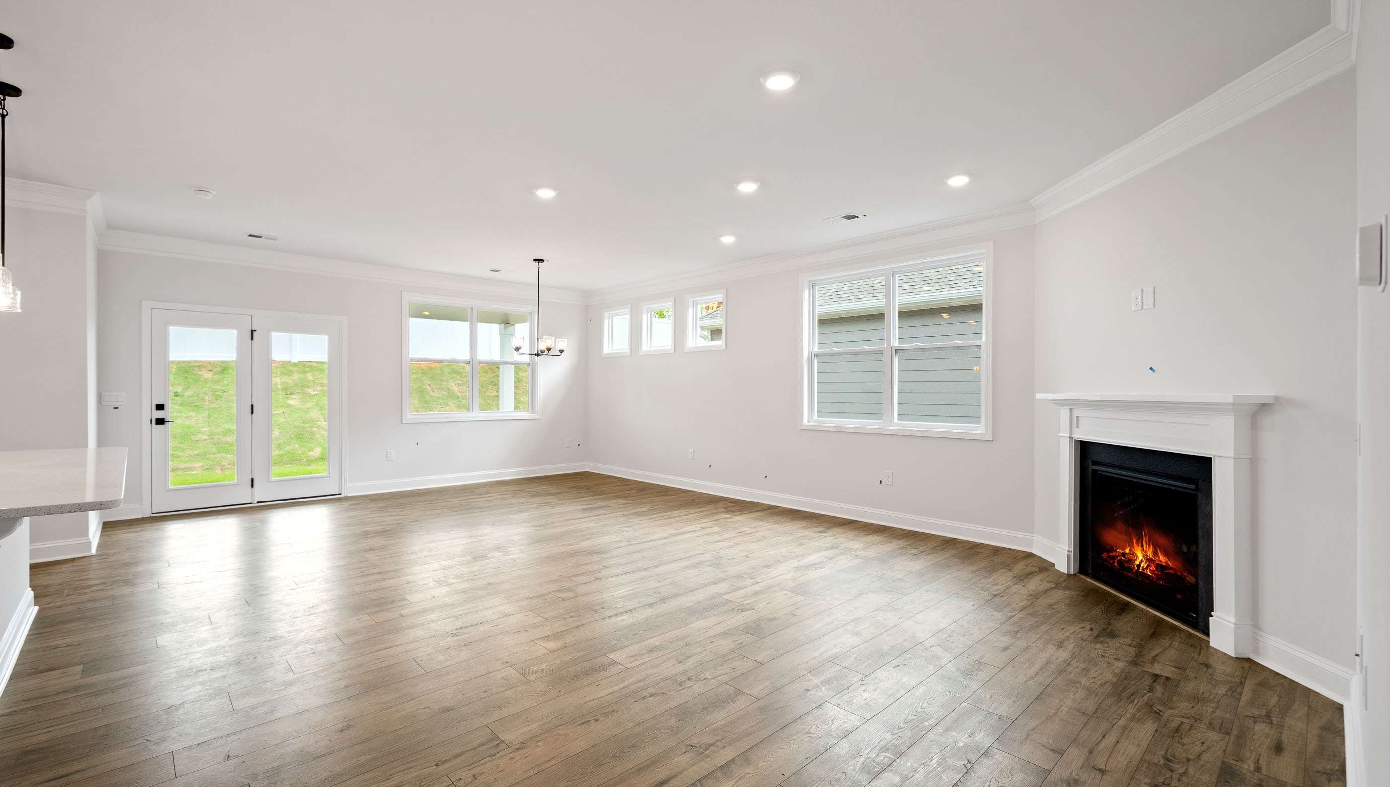 Great Room with fireplace and windows.