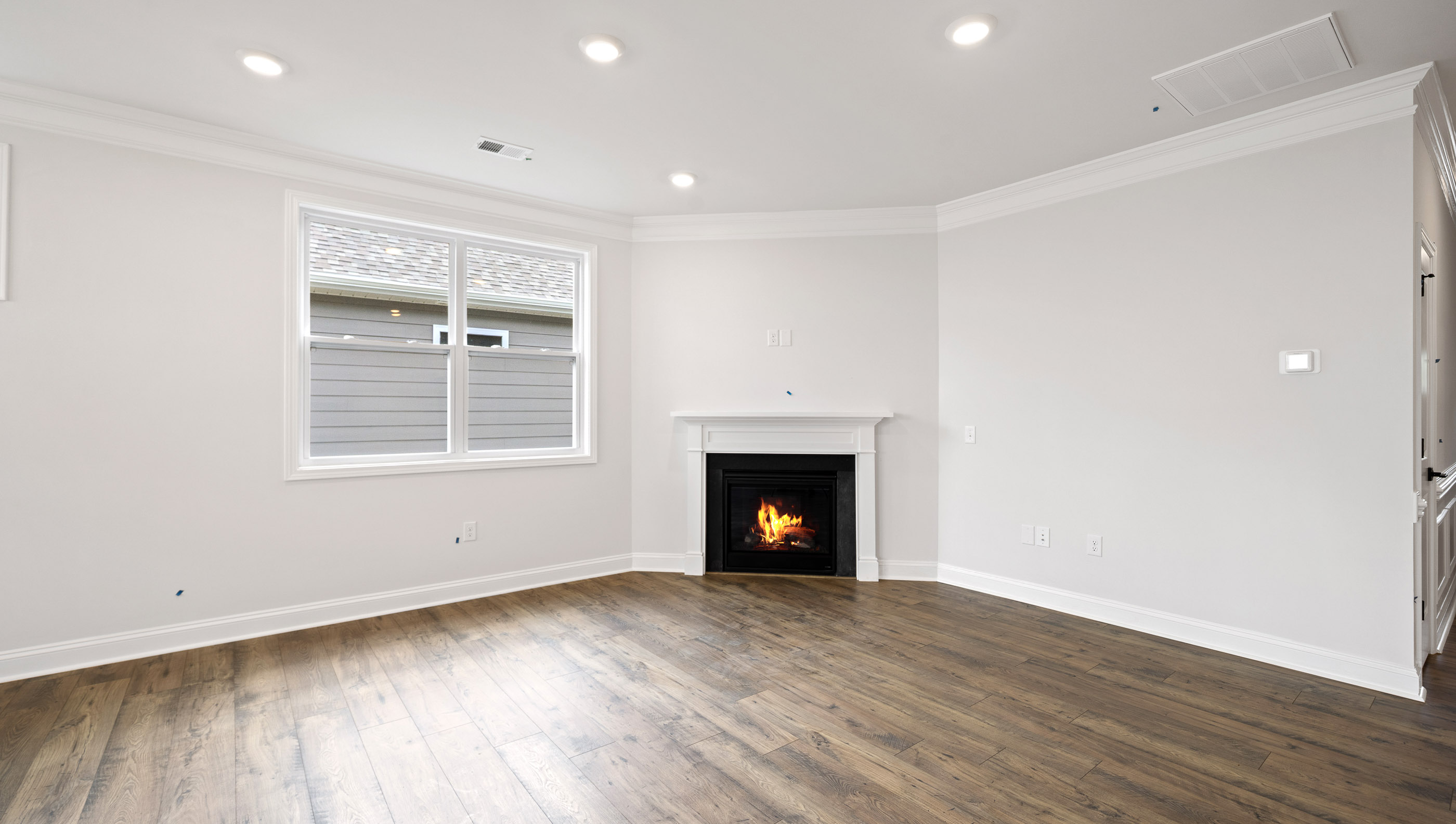 Great Room with fireplace and windows.