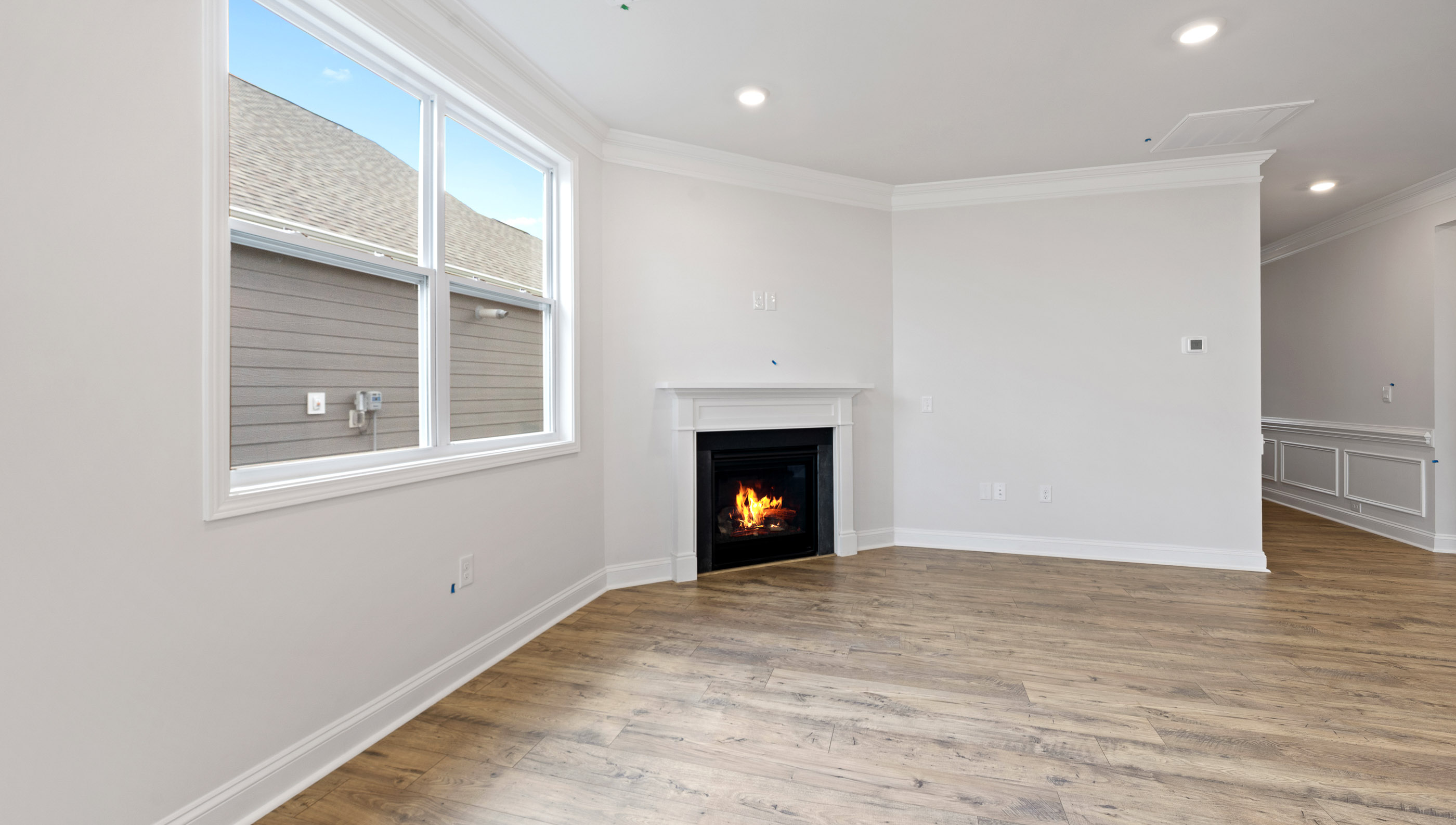 Great Room with fireplace and windows.