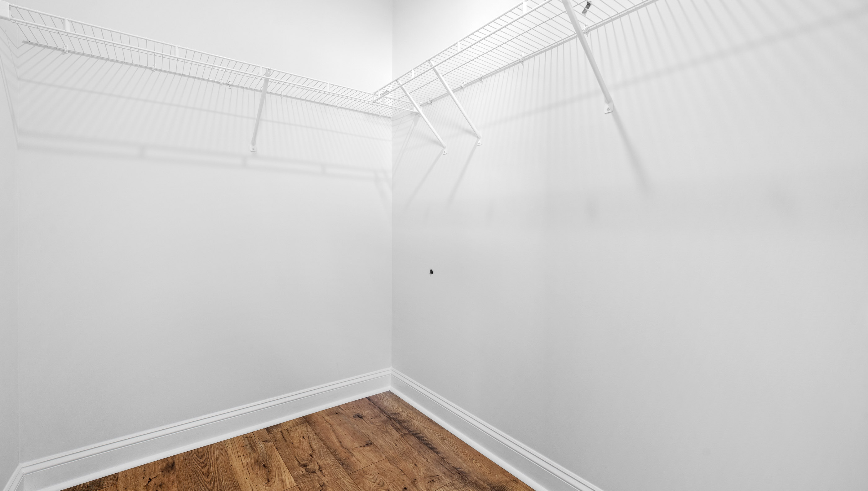 Walk in closet with shelves.