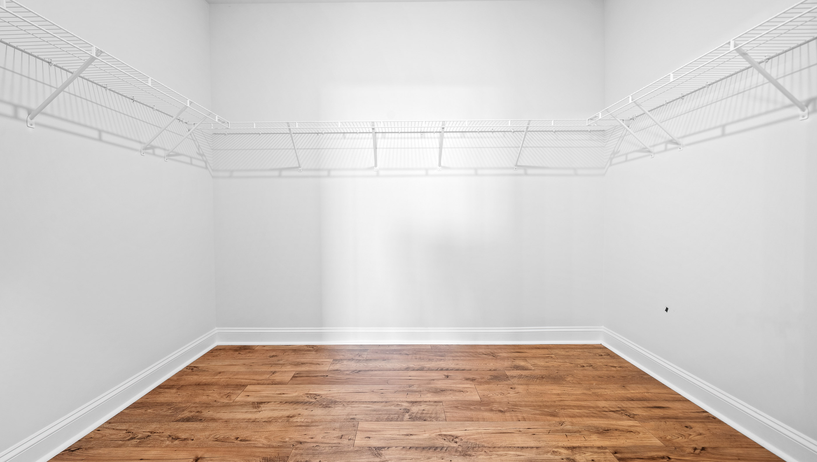 Walk in closet with shelves.