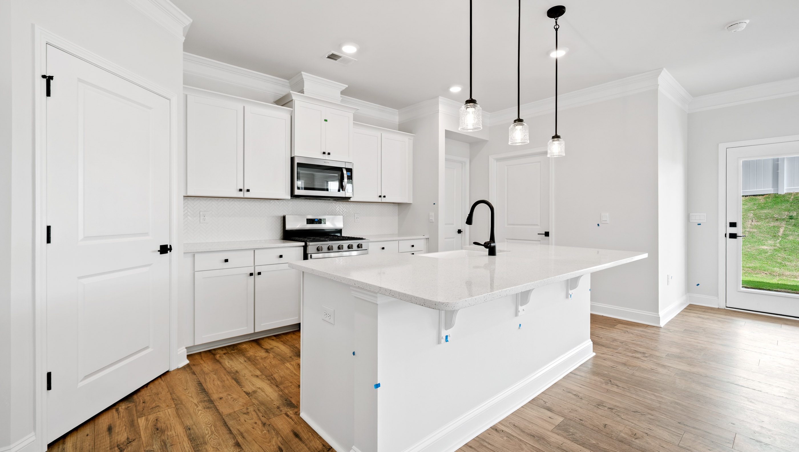 Kitchen and island with granite counter tops.