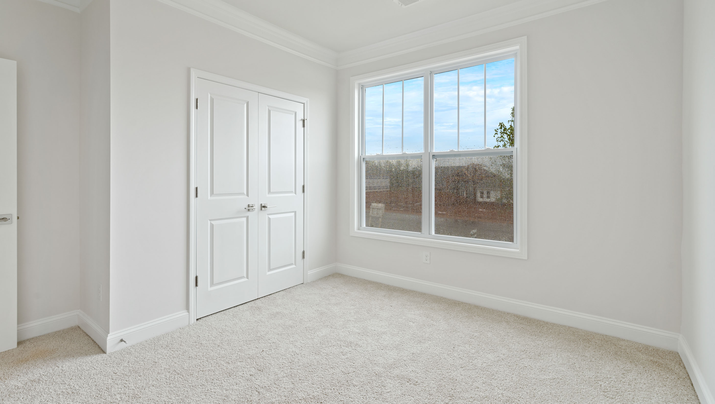 Bedroom with carpet and window.a