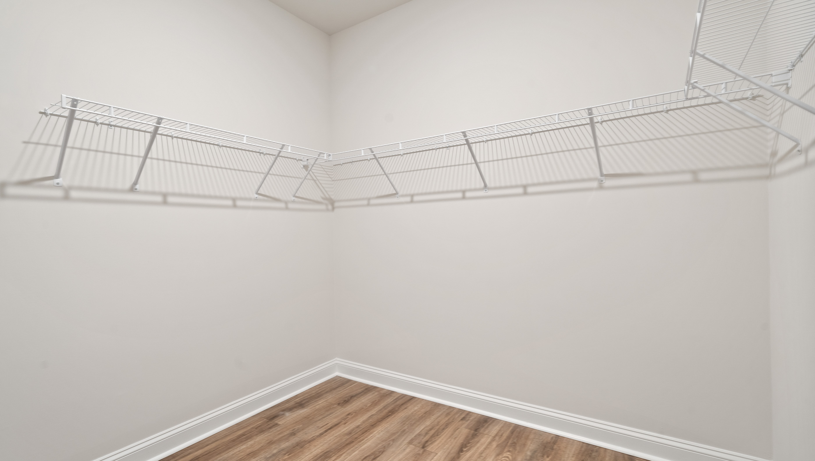 Closet with hanging storage racks.