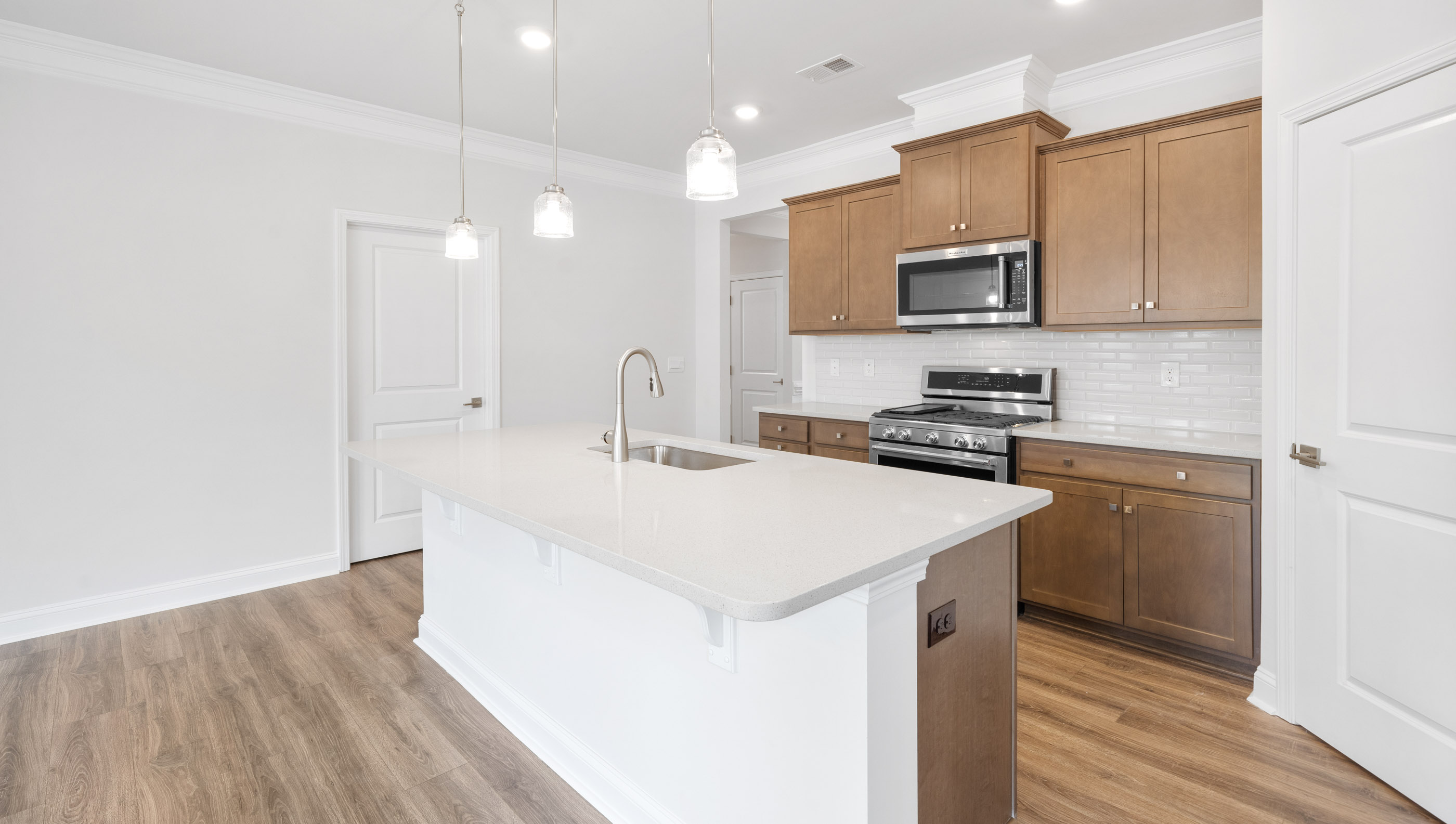 Kitchen and island with granite counter tops.