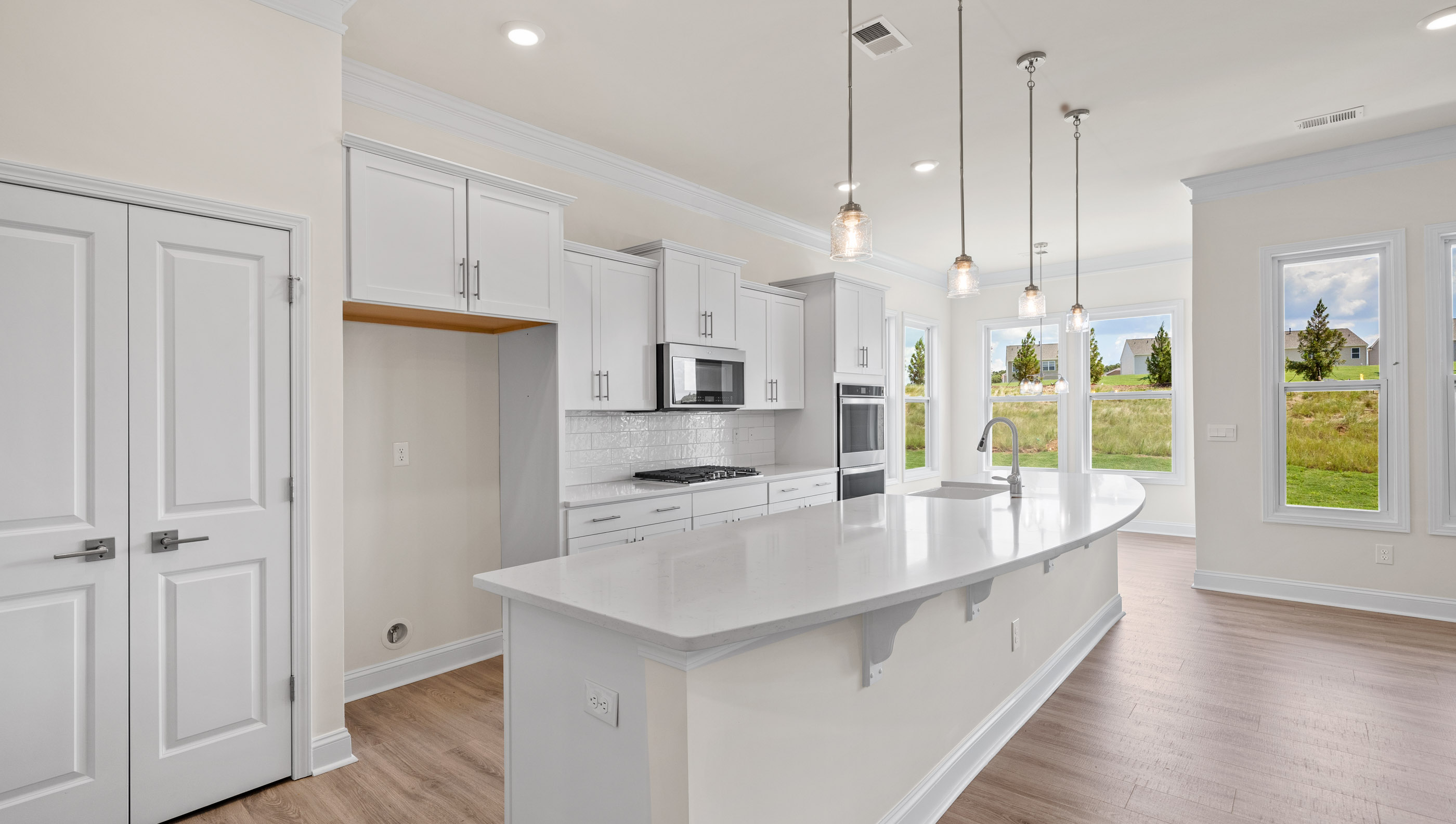 Kitchen and island with quartz countertops.