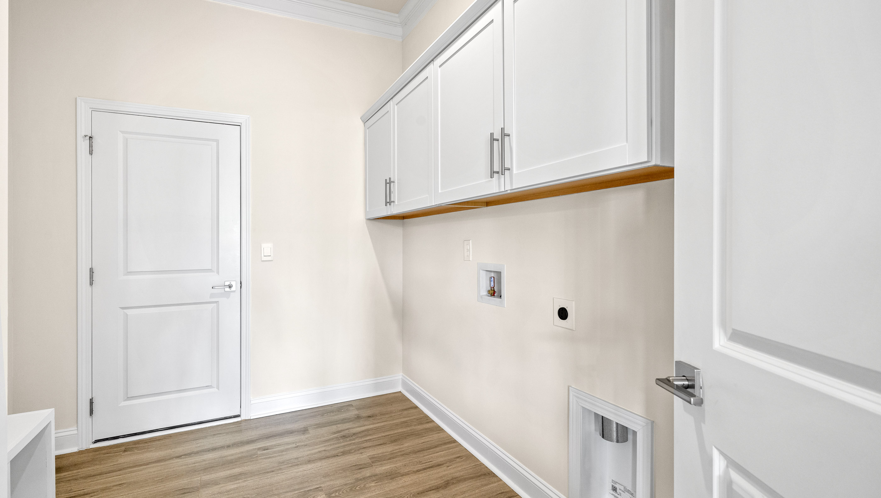 Laundry room with cabinets.
