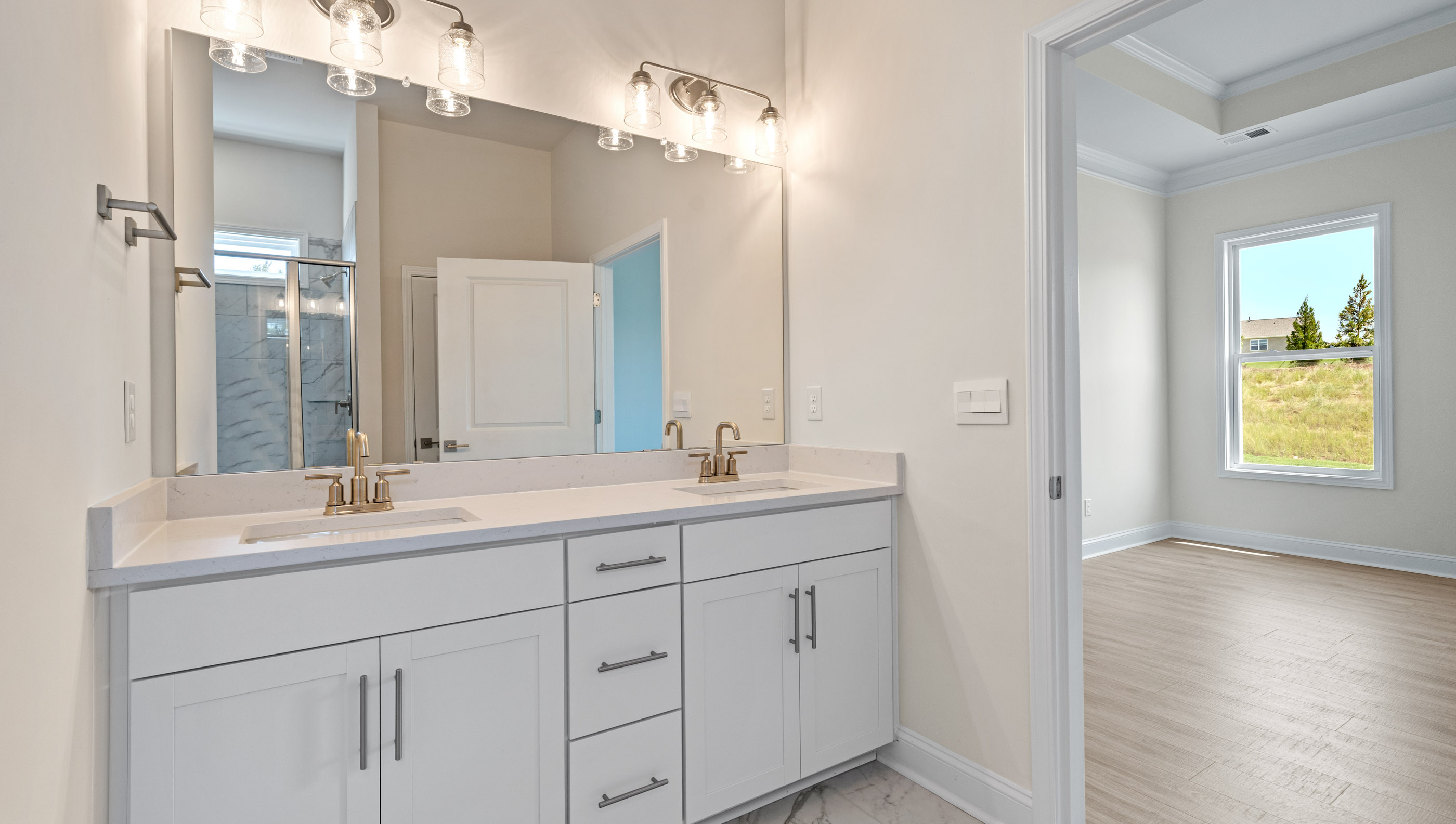 Primary bathroom with dual vanity.