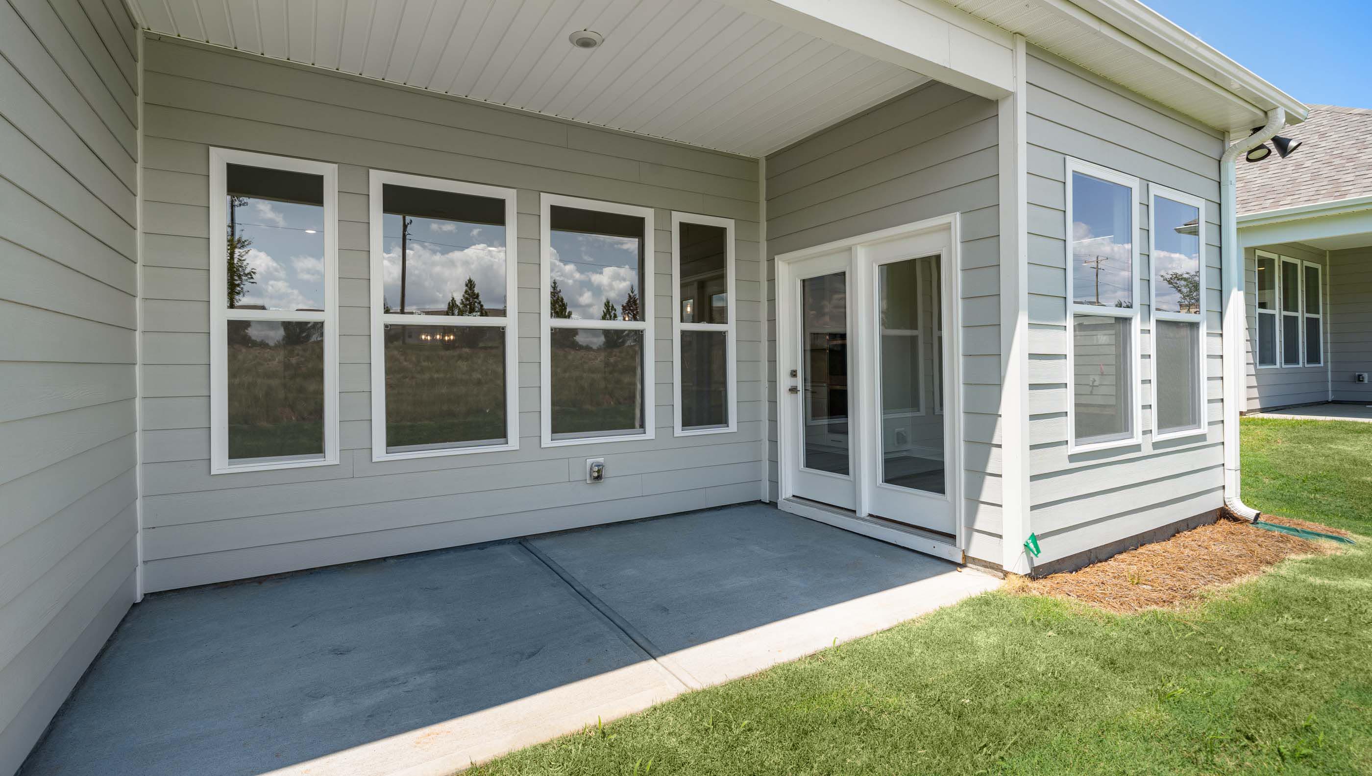 Exterior rear of home with covered porch.