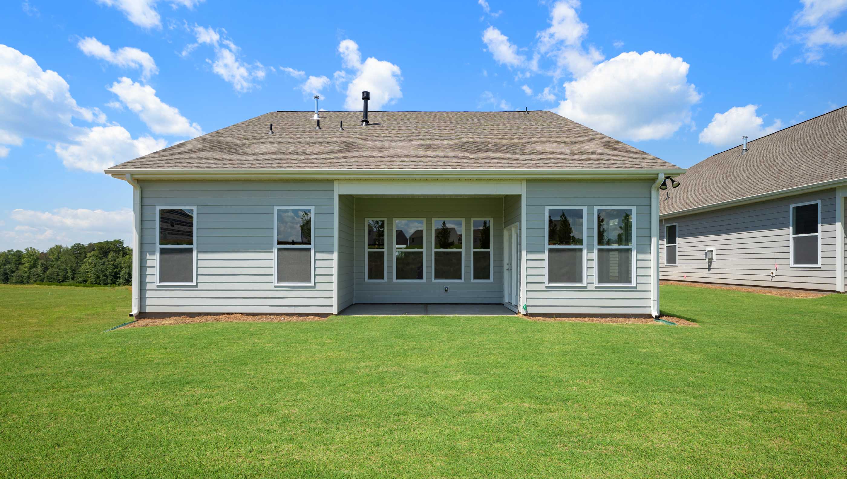 Exterior rear of home with covered porch.
